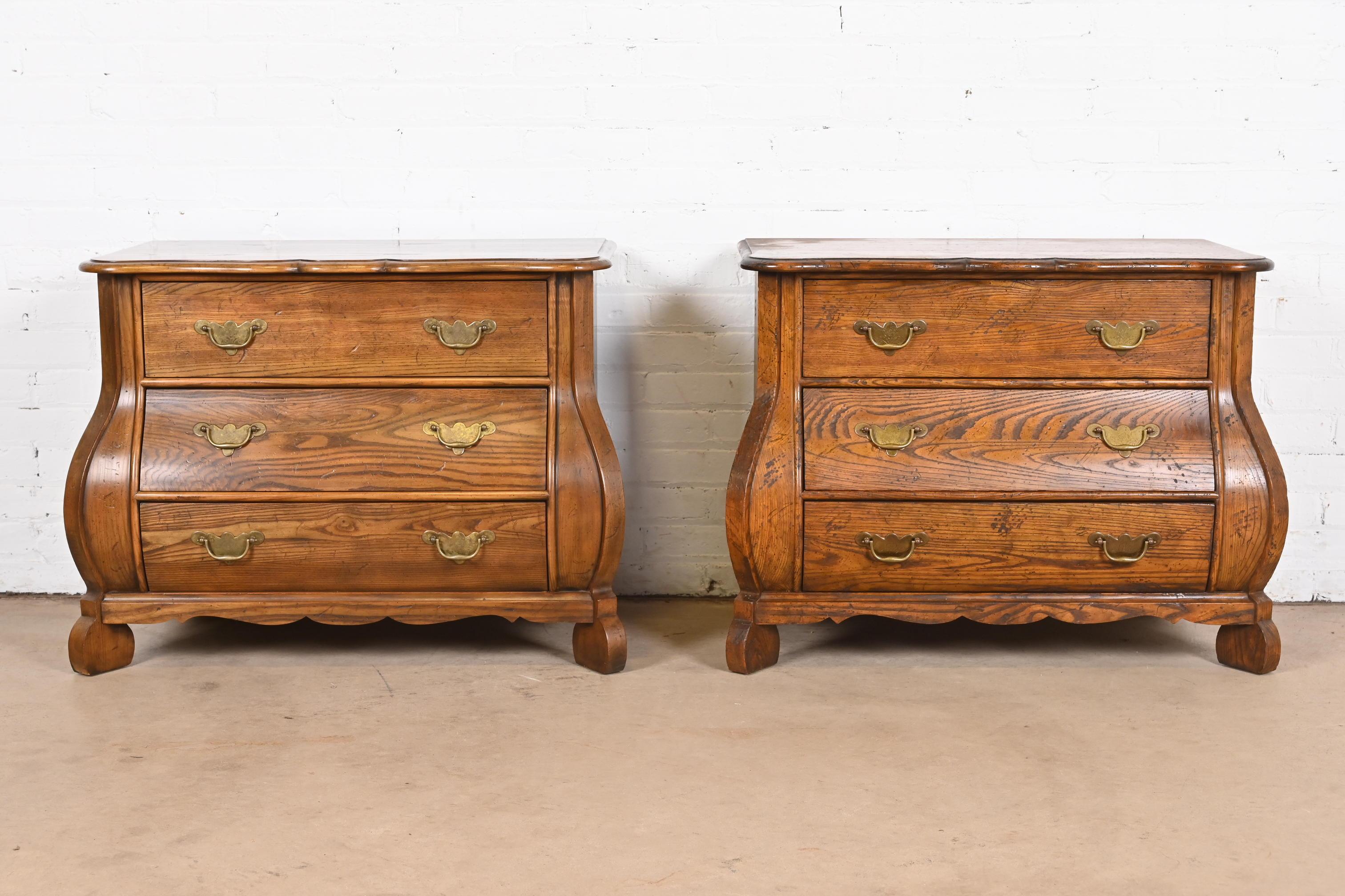 A gorgeous pair of Dutch or French Provincial Louis XV style bombay chests, commodes, or dressers

By Baker Furniture

USA, Circa 1960s

Solid oak, with original brass hardware.

Measures: 33.75