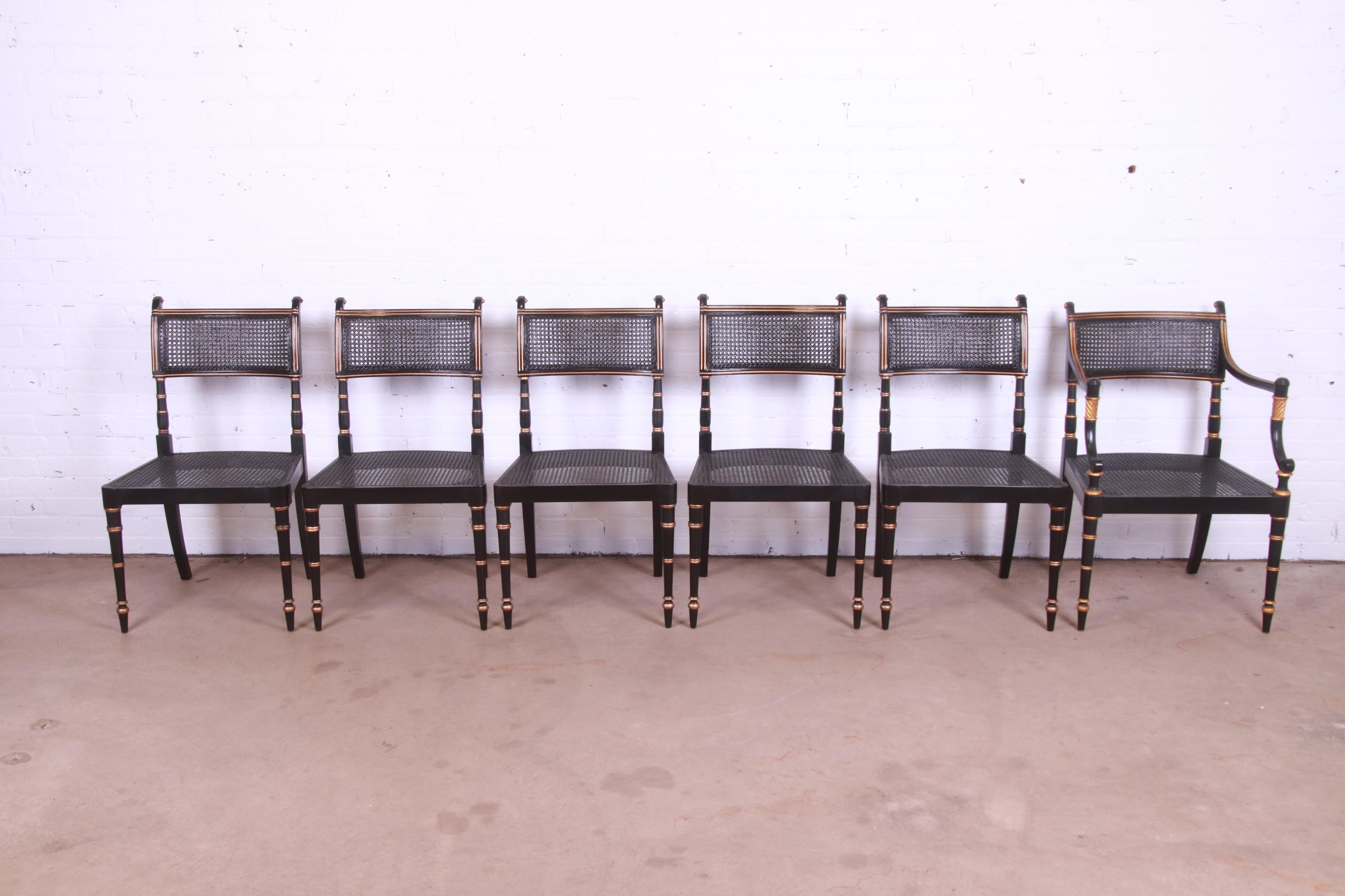 A gorgeous set of six Regency style dining chairs

By Baker Furniture

USA, Circa 1980s

Ebonized and gold gilt wood frames, with caned seats and backs.

Measures:
Side chairs - 20.25
