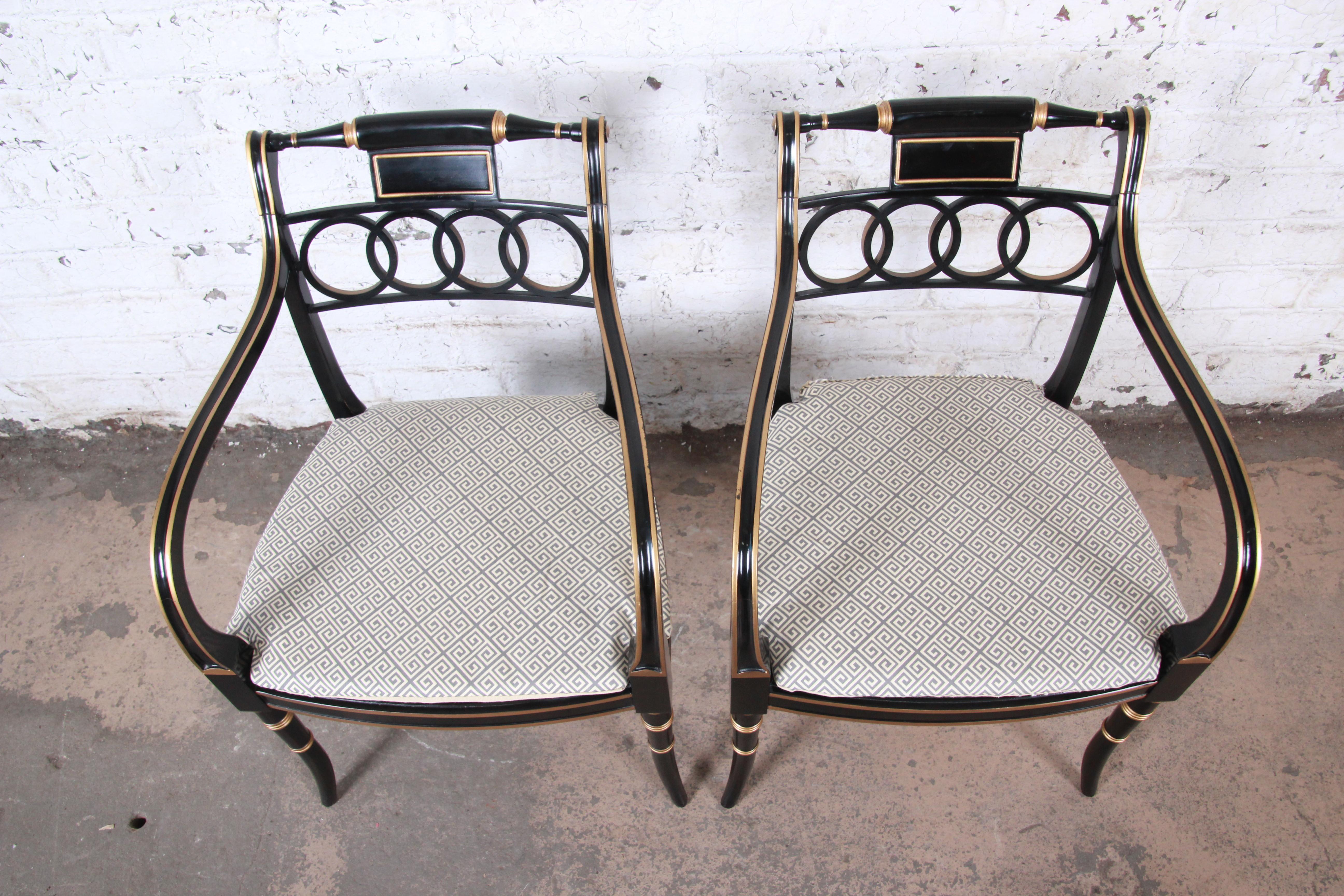 Cane Baker Furniture Ebonized and Gold Gilt Regency Style Armchairs, Pair