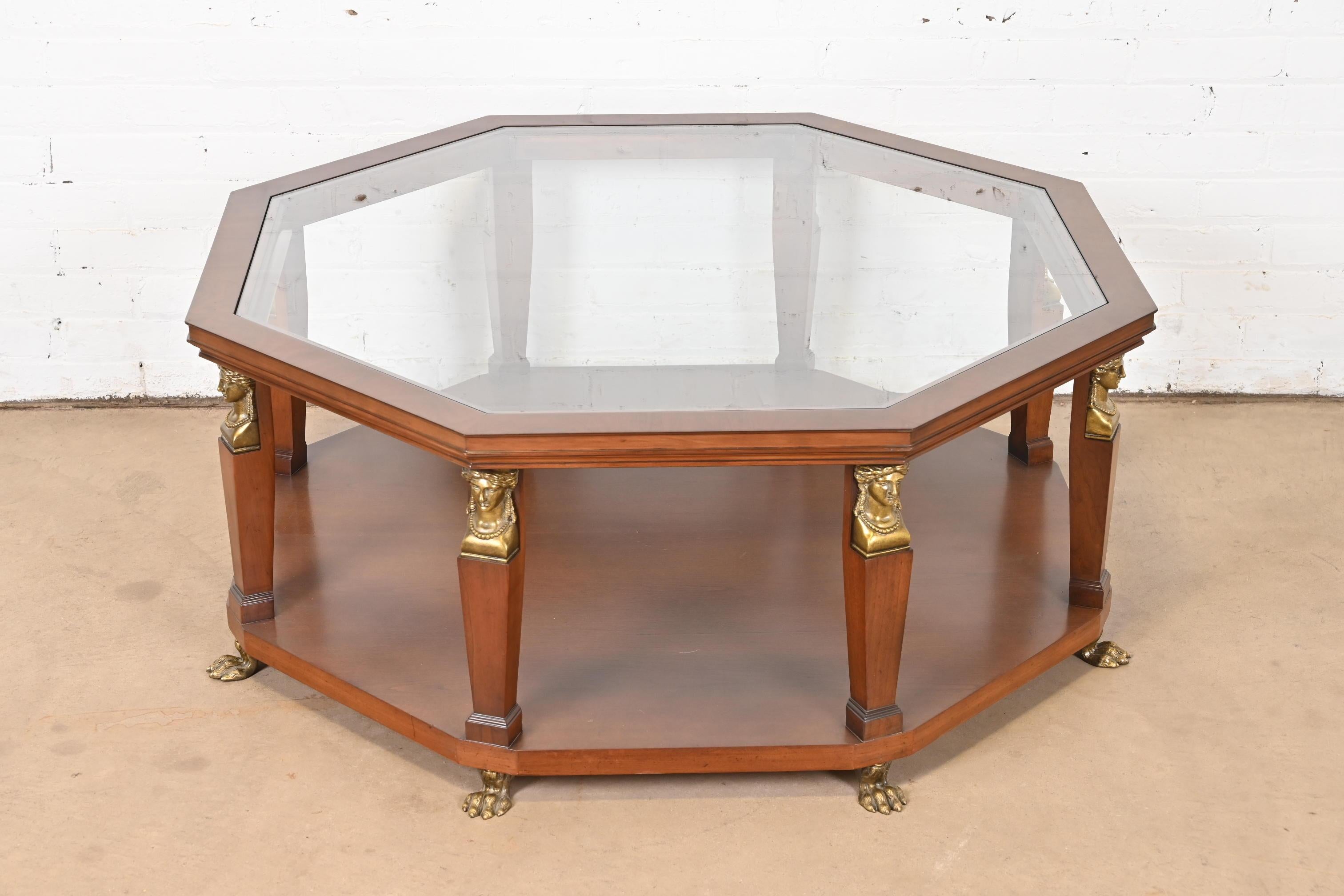 A gorgeous Egyptian Revival or Neoclassical coffee or cocktail table

By Baker Furniture

USA, Late 20th Century

Walnut, with mounted brass busts and paw feet, and inset glass top.

Measures: 42.25