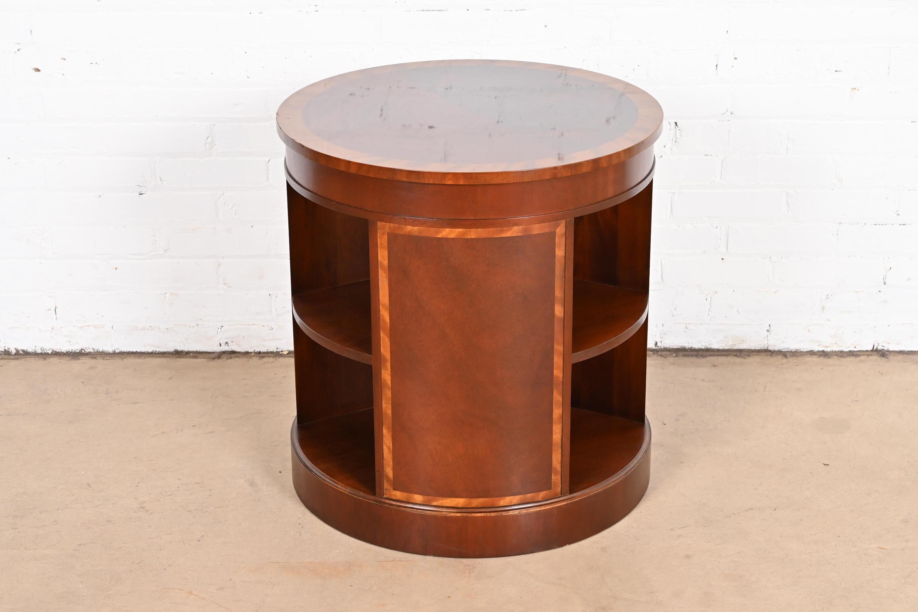 A gorgeous Empire or Georgian style drum side table or tea table

By Baker Furniture

USA, circa 1980s

Beautiful flame mahogany, with satinwood banding.

Measures: 24