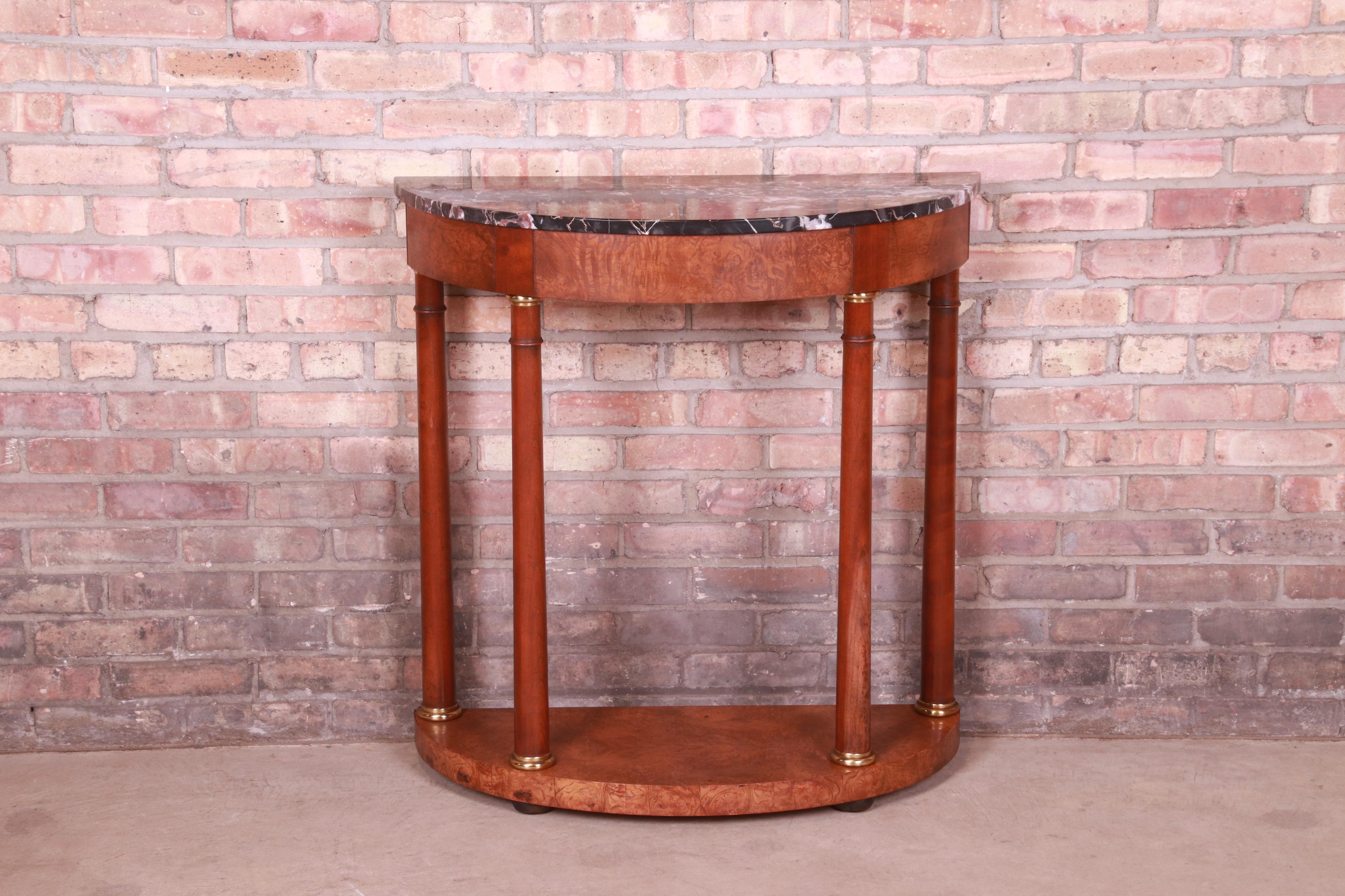 A gorgeous Empire or neoclassical style console or entry table

By Baker Furniture

USA, Circa 1980s

Cherry and olive ash burl wood, with brass accents and Italian marble top.

Measures: 32.25