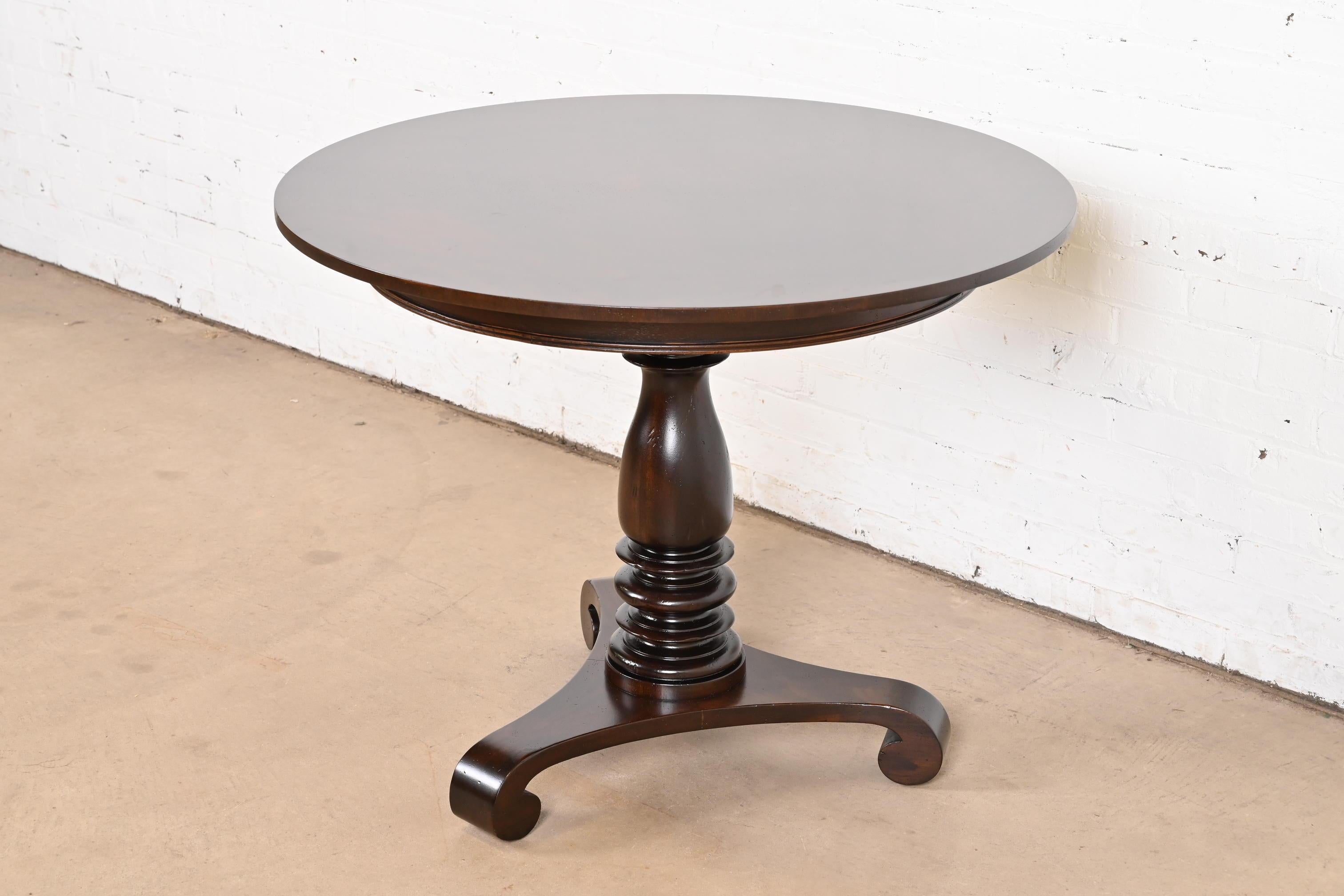 A gorgeous Empire style carved mahogany pedestal tea table or center table

By Baker Furniture, 