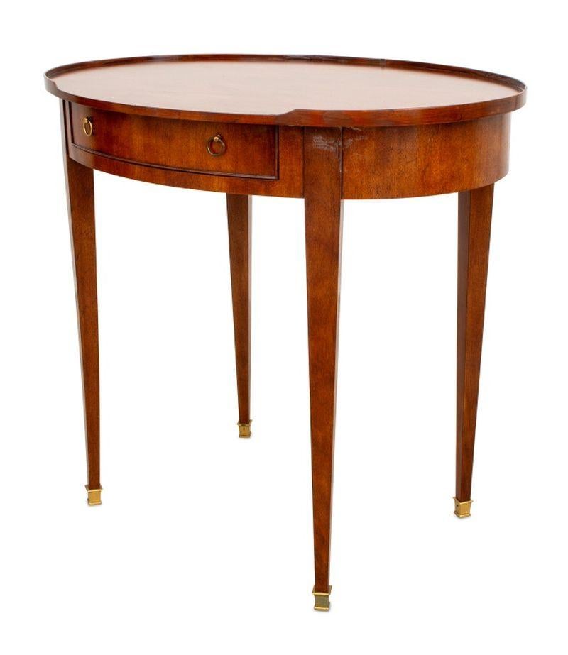 Baker Furniture Empire Style Walnut Oval Lamp Table, with central drawer having brass ring handles, on four fluted tapered legs and brass tips, with 