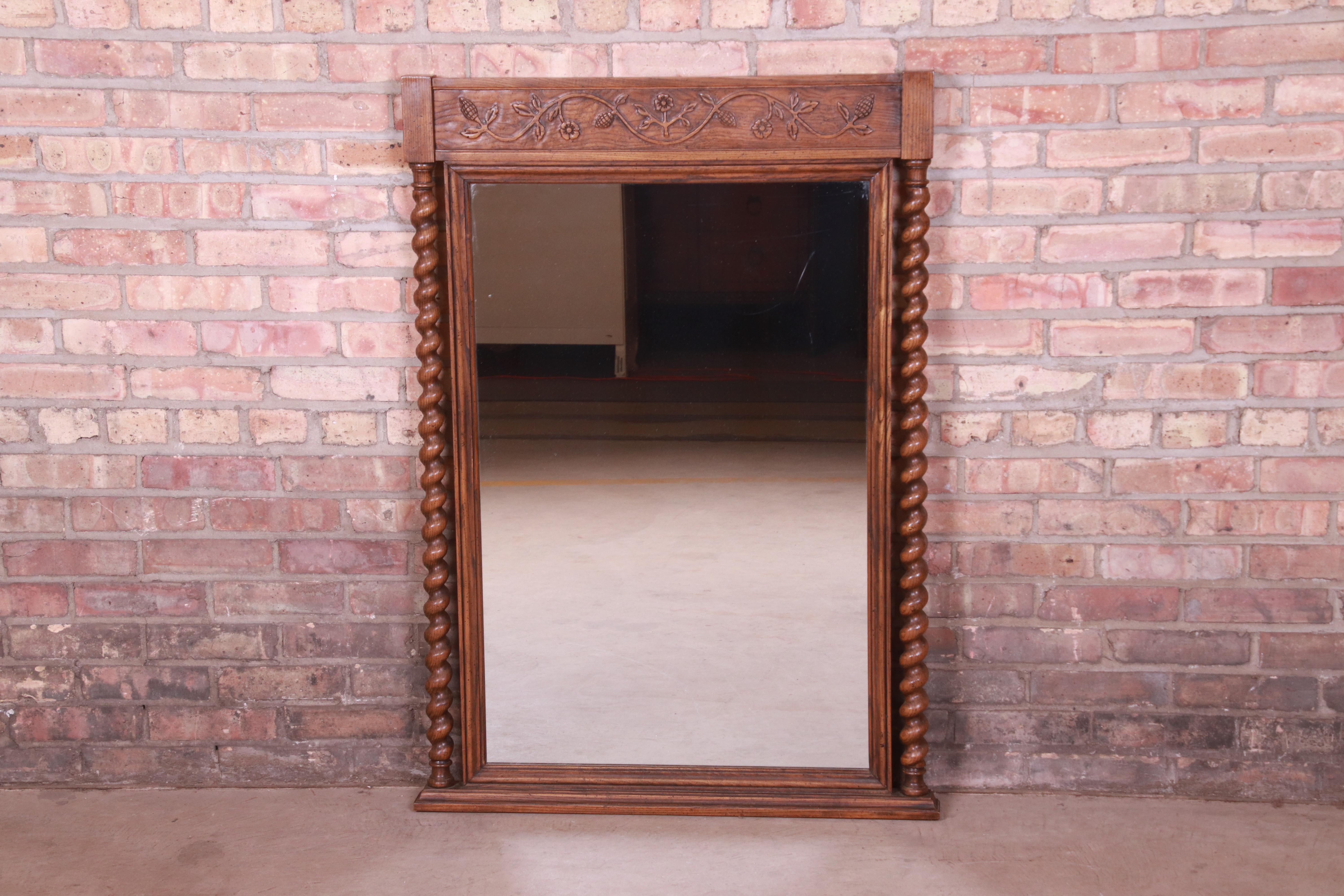 A gorgeous English barley twist carved oak framed wall mirror

By Baker Furniture, 