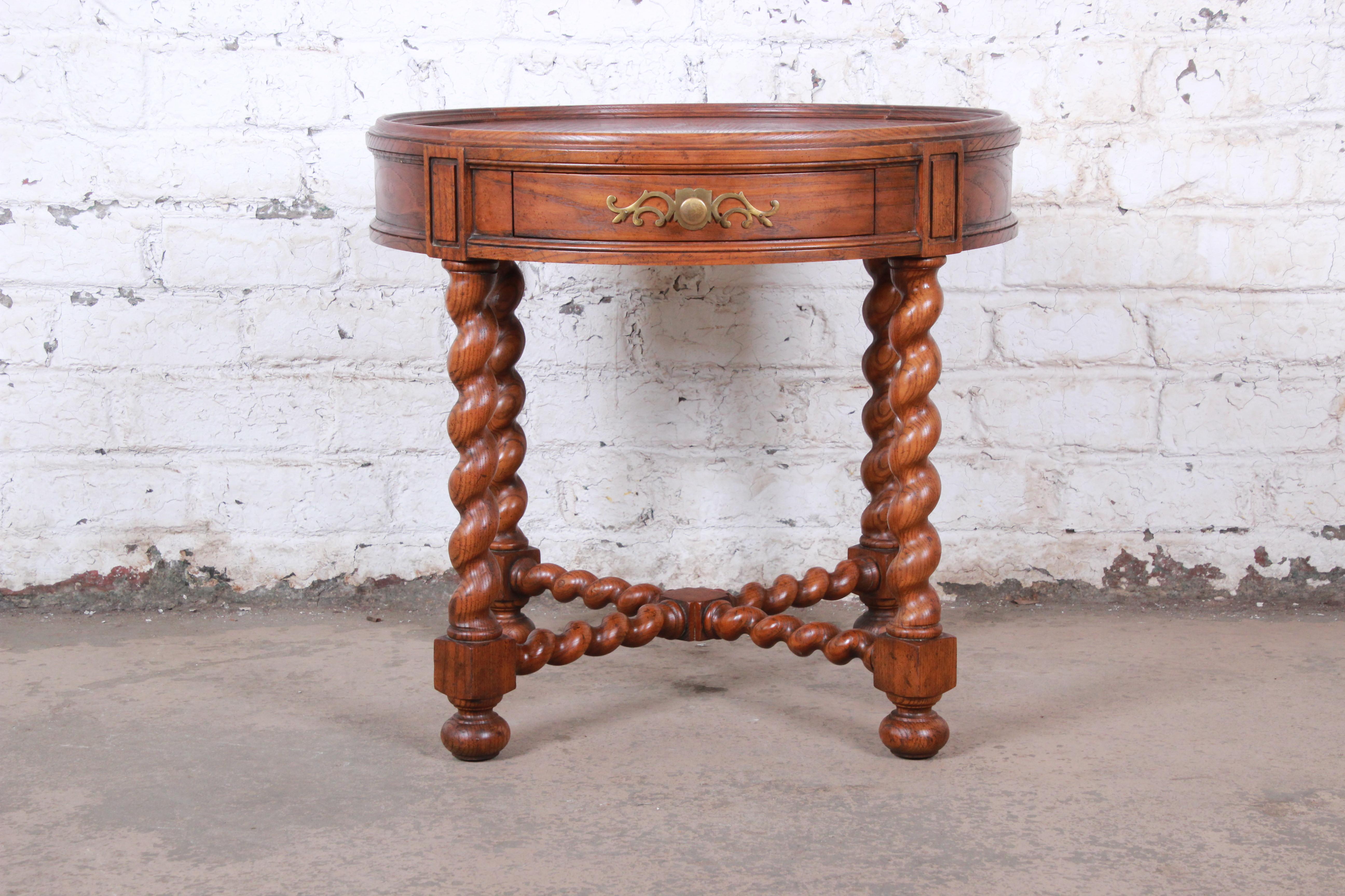 A gorgeous oak and burl wood English barley twist tea table or occasional side table

By Baker Furniture

USA, circa 1960s

Oak and burl wood and brass hardware

Measures: 26.13