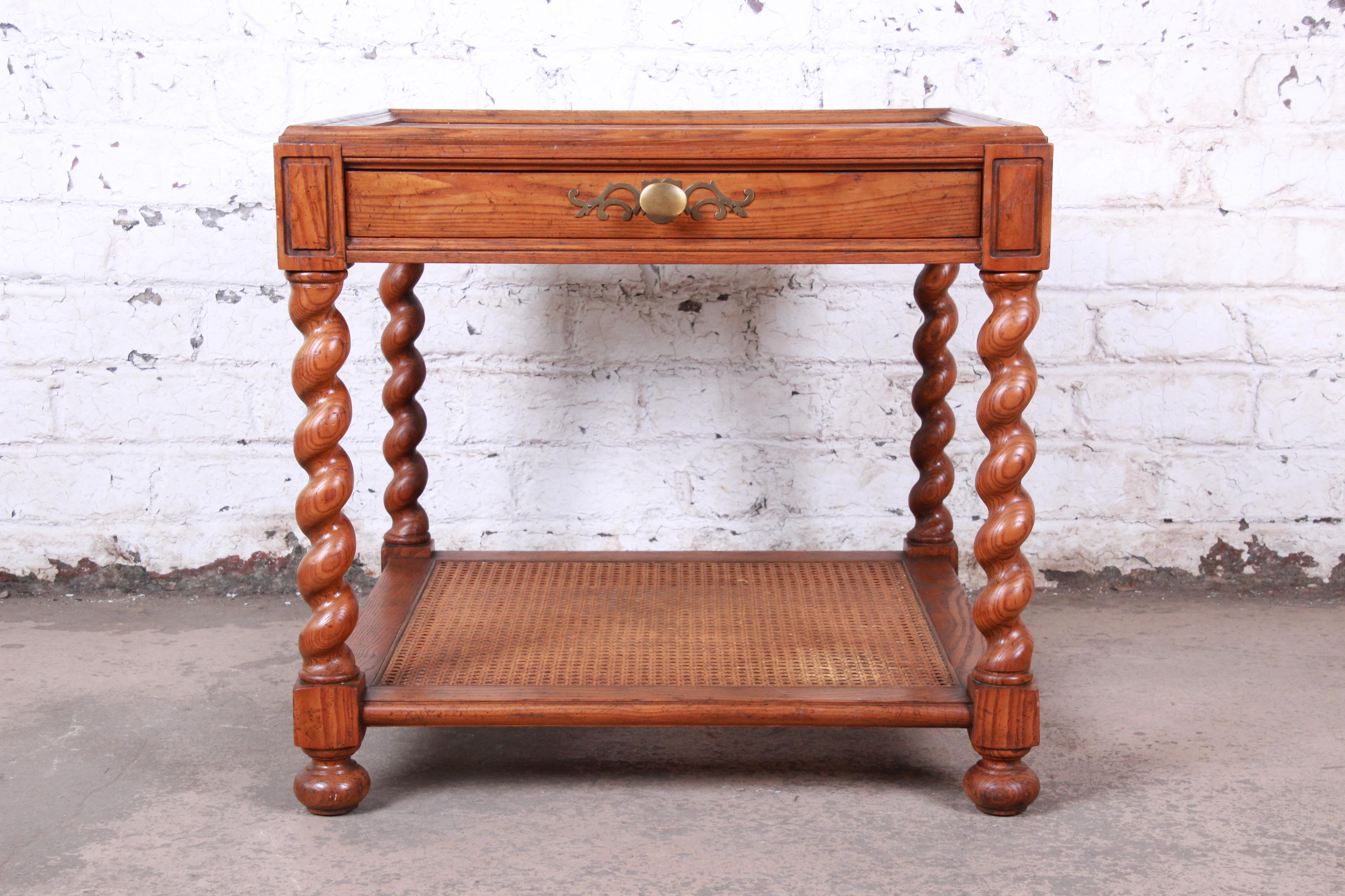 A gorgeous English barley twist tea table or occasional side table with parquetry top

By Baker Furniture

USA, circa 1960s

Oak and burl wood and cane and brass hardware

Measures: 26.13