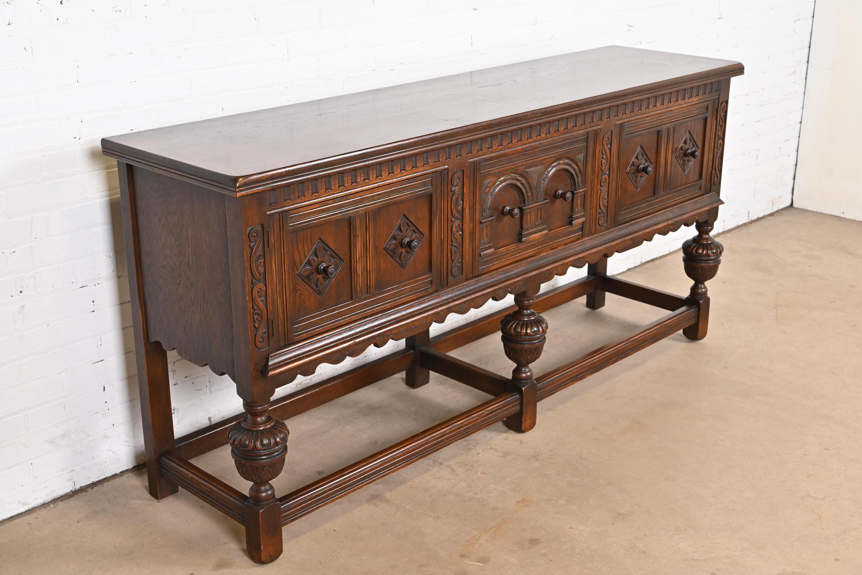 Early 20th Century Baker Furniture English Jacobean Ornate Carved Oak Sideboard or Credenza