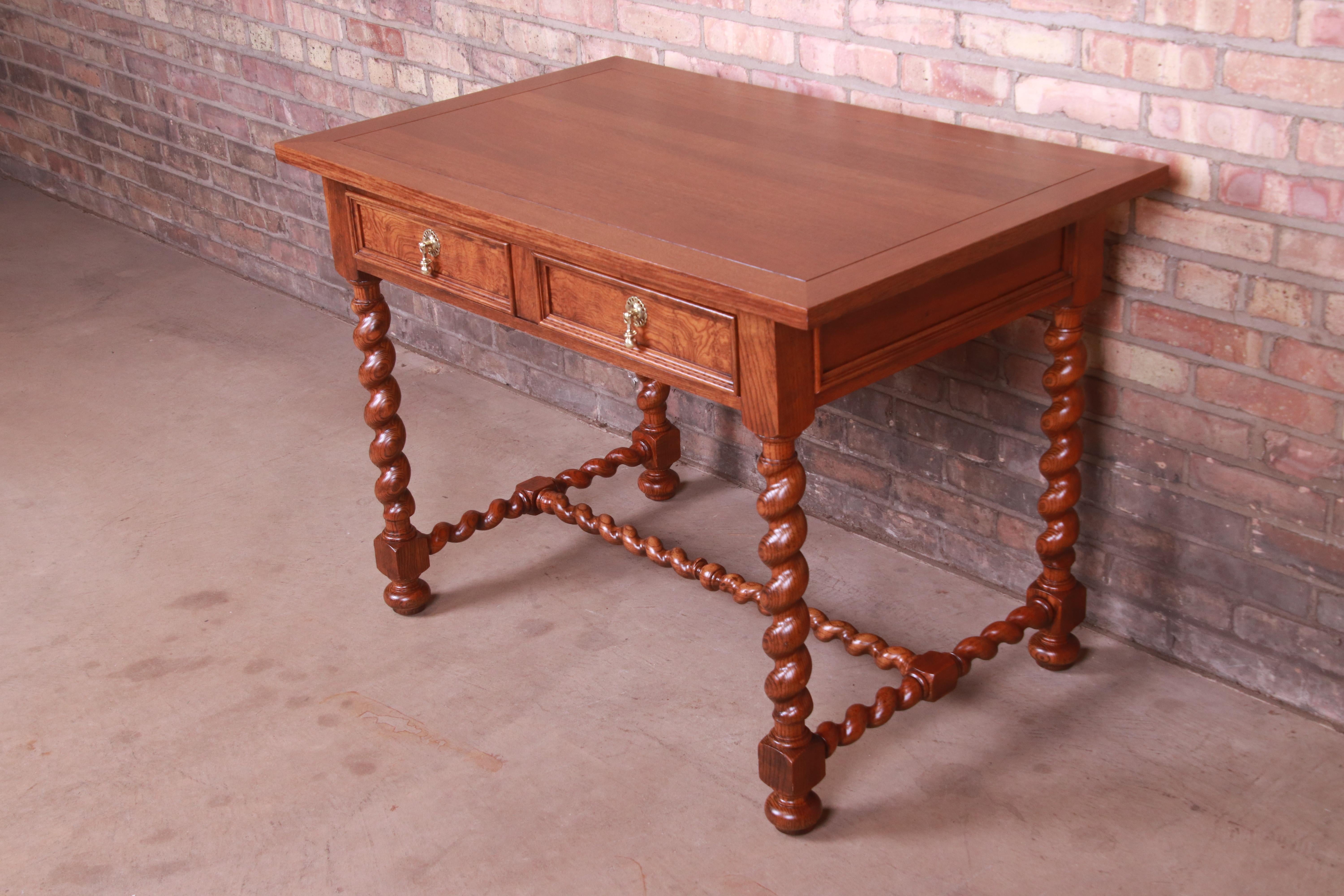 An exceptional English style writing desk or library table with barley twist legs

By Baker Furniture

USA, Circa 1960s

Carved oak, with burl wood drawer front and original brass hardware.

Measures: 42