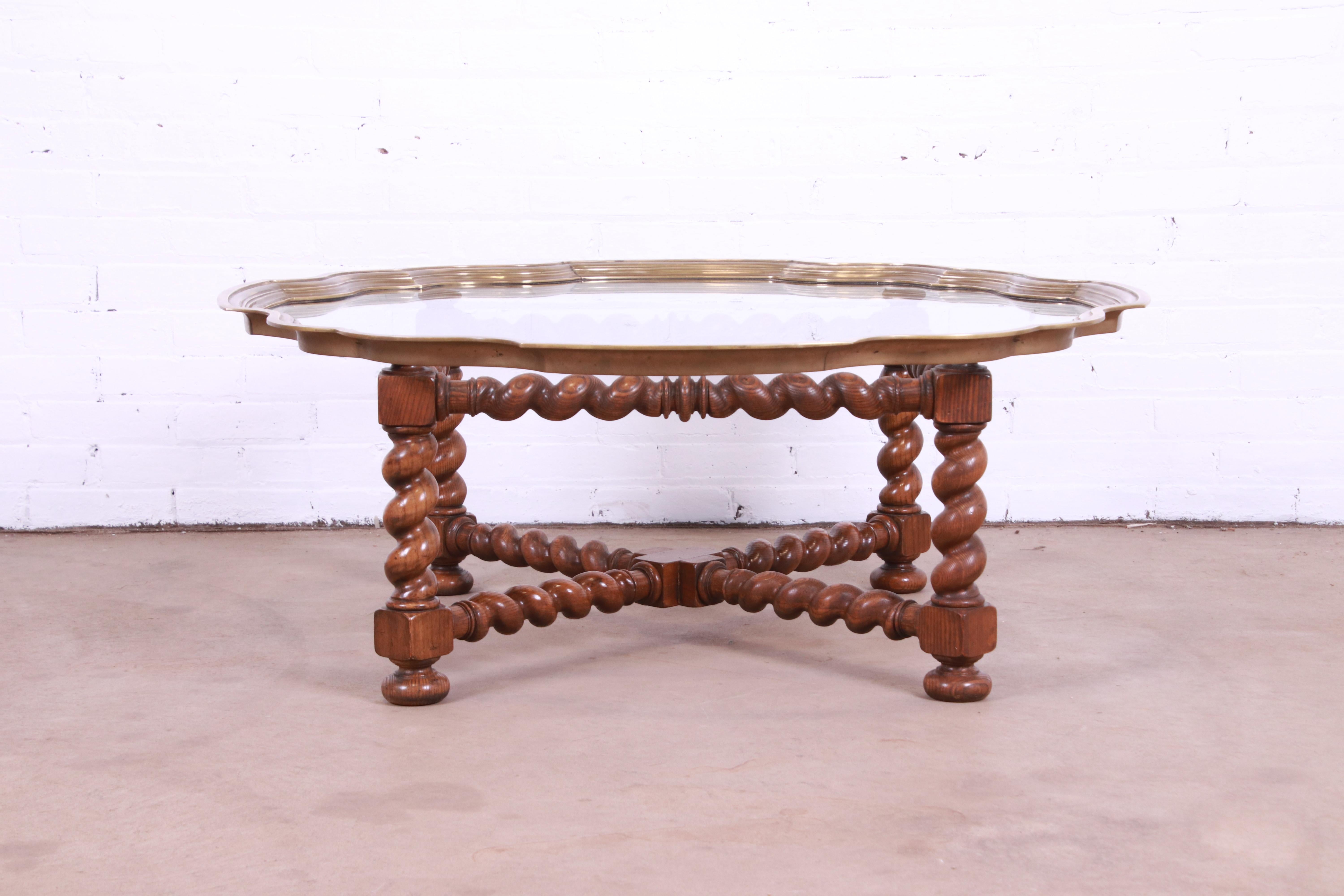 A gorgeous brass and glass tray on turned oak base coffee or cocktail table

By Baker Furniture

USA, Circa 1960s

Turned oak base in barley twist form, with scalloped brass and glass top.

Measures: 44