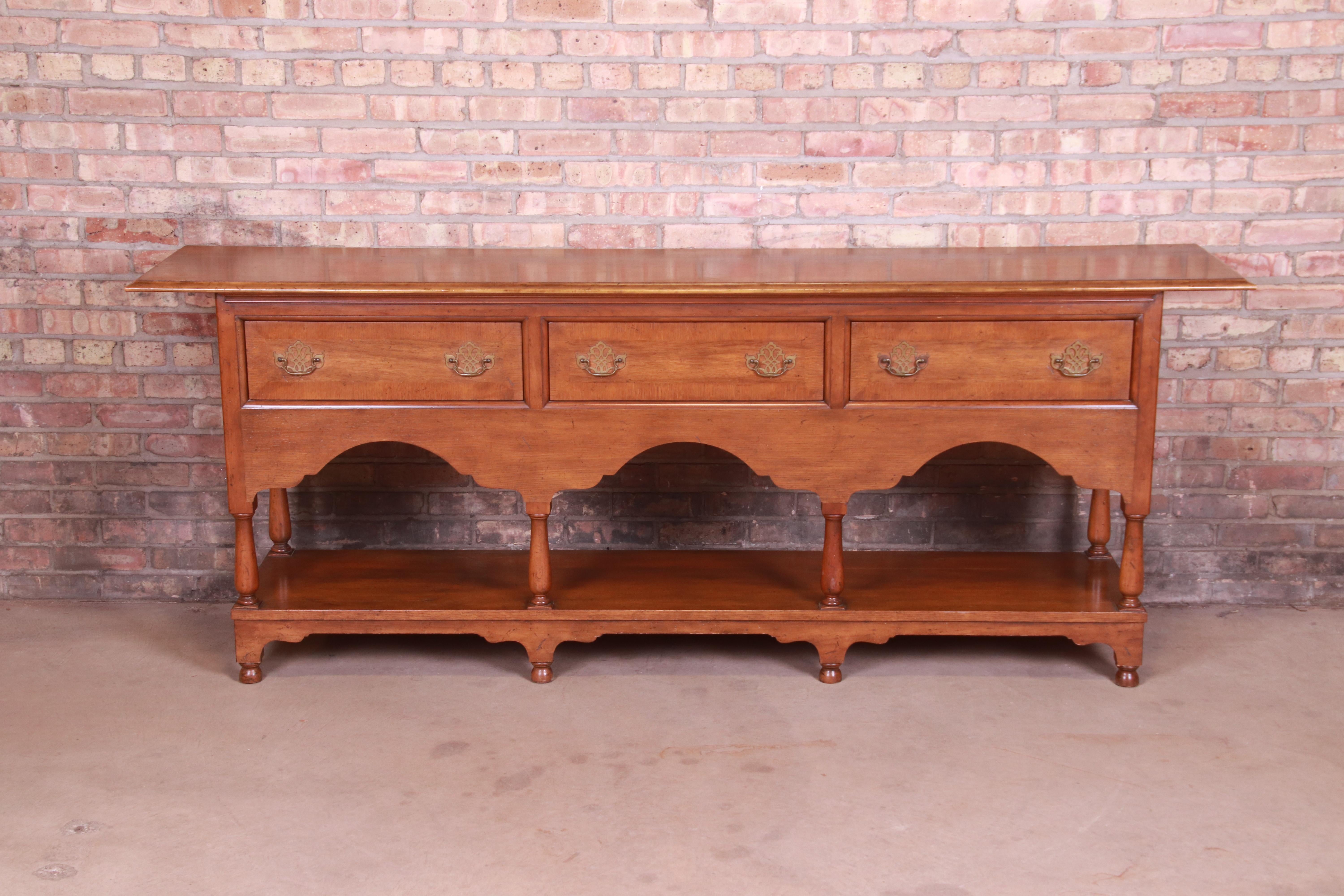 A gorgeous English Provincial country oak sideboard or credenza.

By Baker Furniture,

USA, late 20th century

Carved oak, with original brass hardware.

Measures: 87.25
