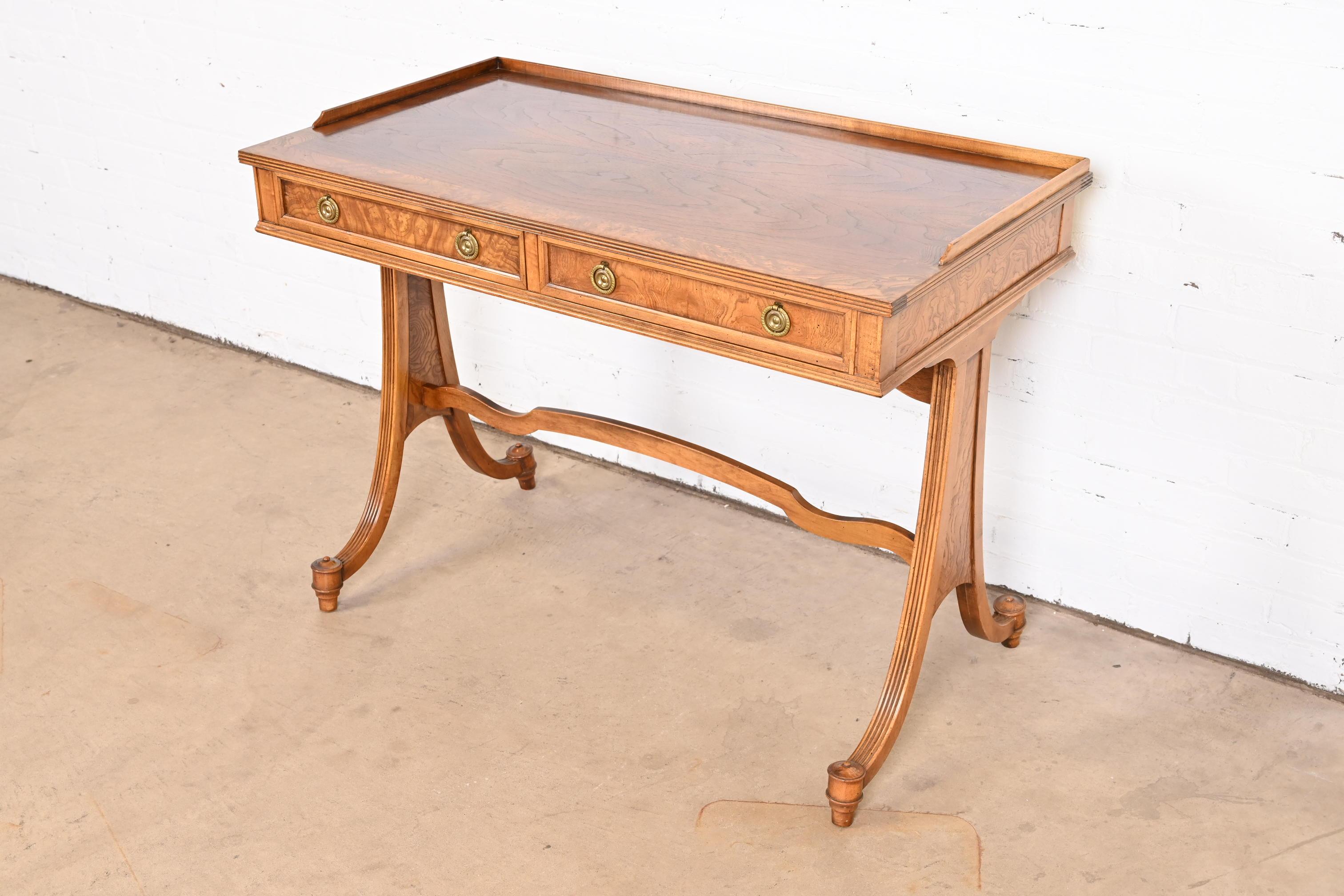 An exceptional Regency style writing desk or console table

By Baker Furniture

USA, Circa 1980s

Burled walnut, with original brass hardware.

Measures: 40