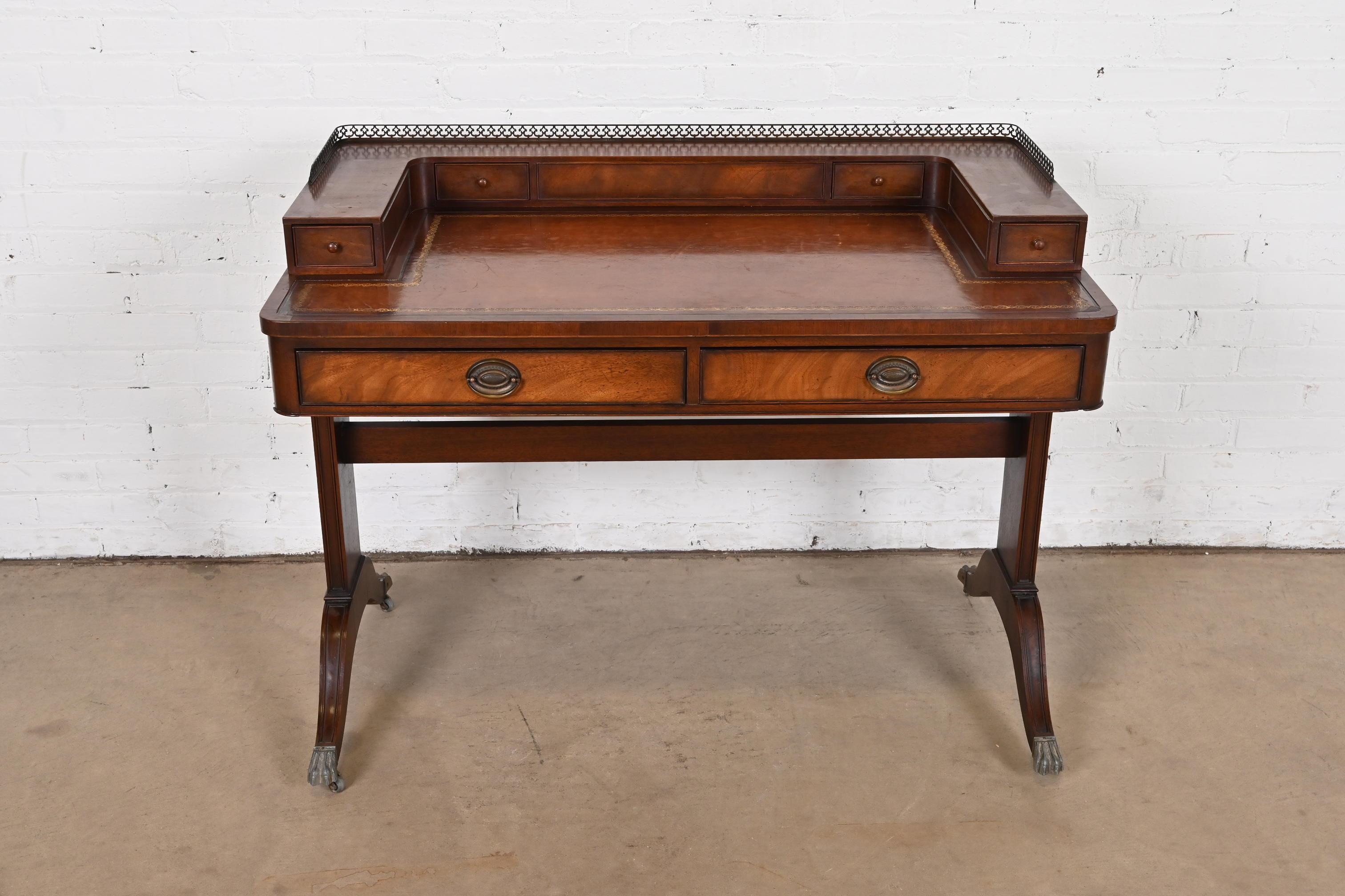 An exceptional English Regency style writing desk or console table

By Baker Furniture

USA, Circa 1940s

Carved mahogany, with embossed leather top, and original brass hardware and gallery.

Measures: 42