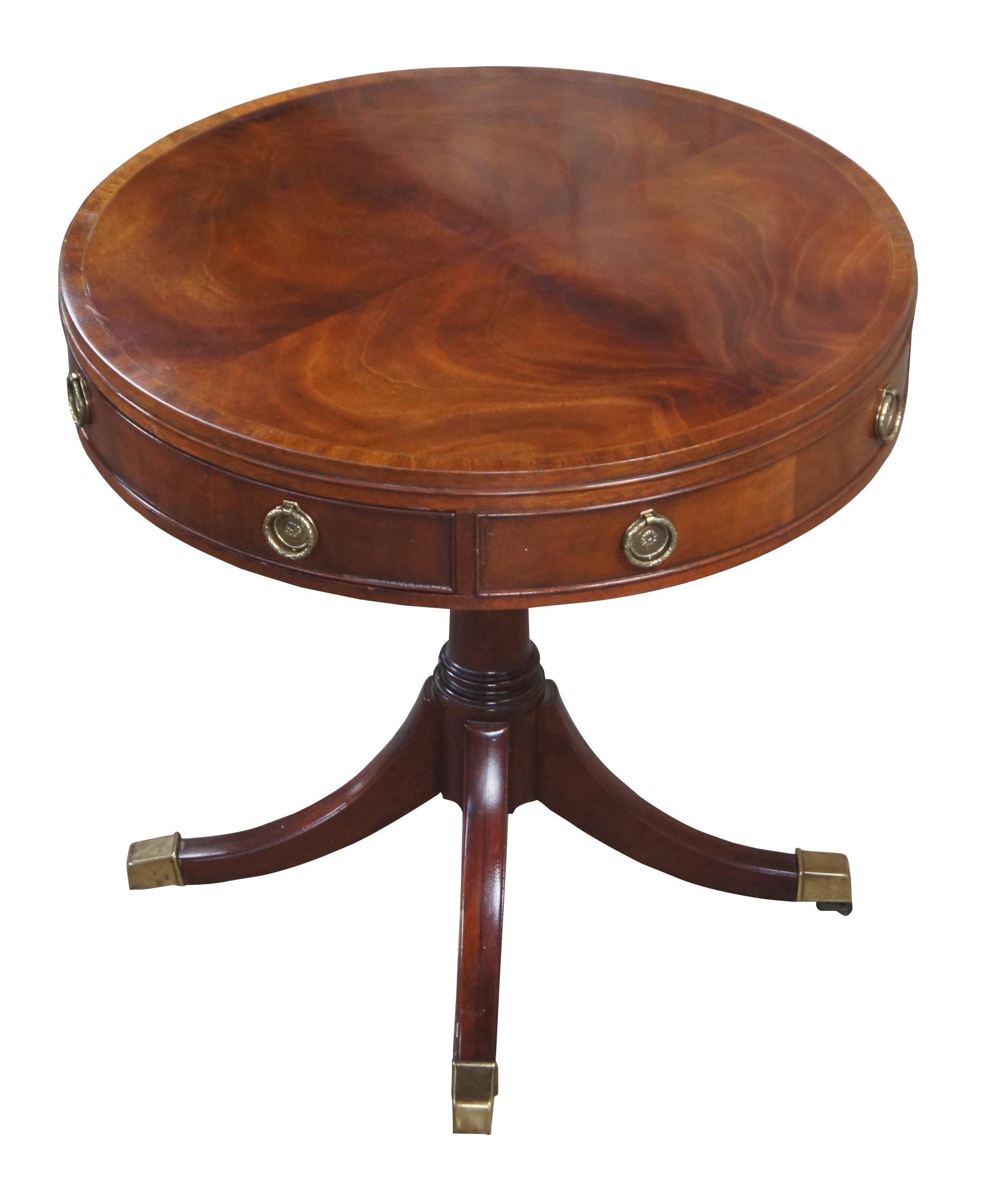 A gorgeous side or accent table by Baker Furniture, Circa last quarter 20th century. Drawing inspiration from English Georgian and Sheraton styling.  Made from mahogany with a matchbook banded and inlayed top.  The frieze features one dovetailed