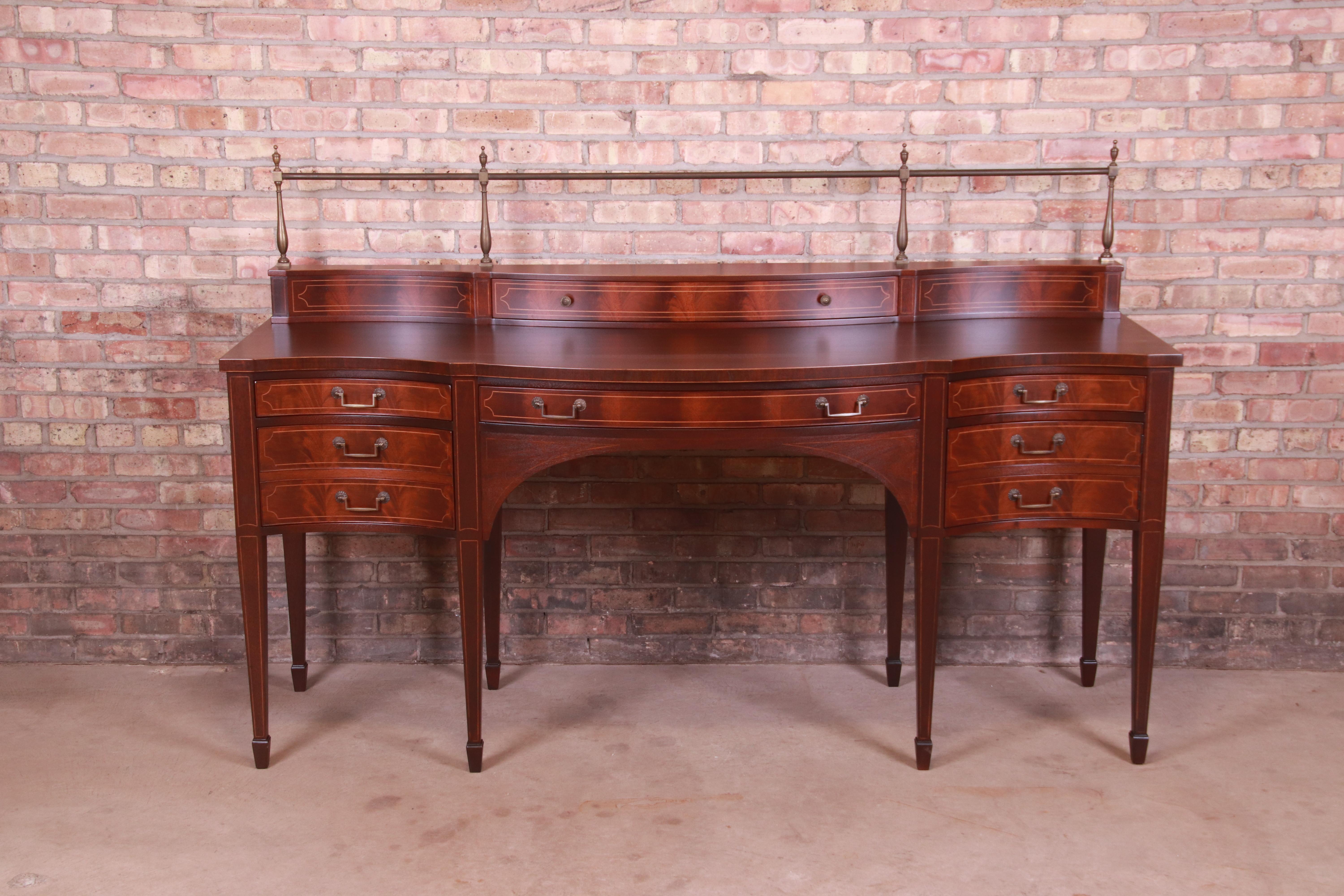 An exceptional Federal or Georgian style sideboard, credenza, or bar cabinet

By Baker Furniture,

USA, Mid-20th century

Book-matched flame mahogany, with satinwood string inlay and original brass hardware and gallery.

Measures: 78