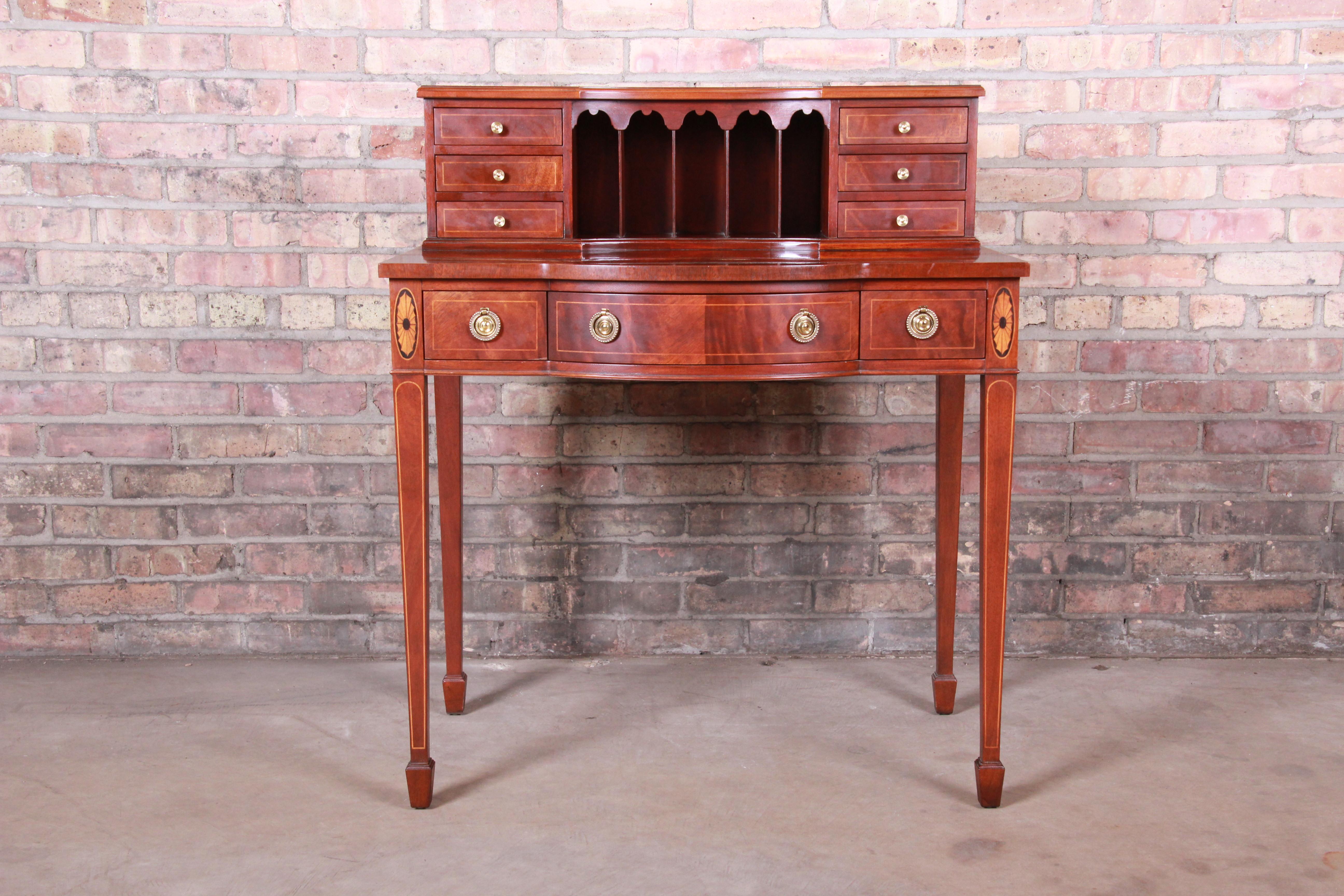 An exceptional Federal style bow front ladies' writing desk

By Baker Furniture

USA, circa 1980s

Inlaid mahogany and satinwood, with original brass hardware.

Measures: 32