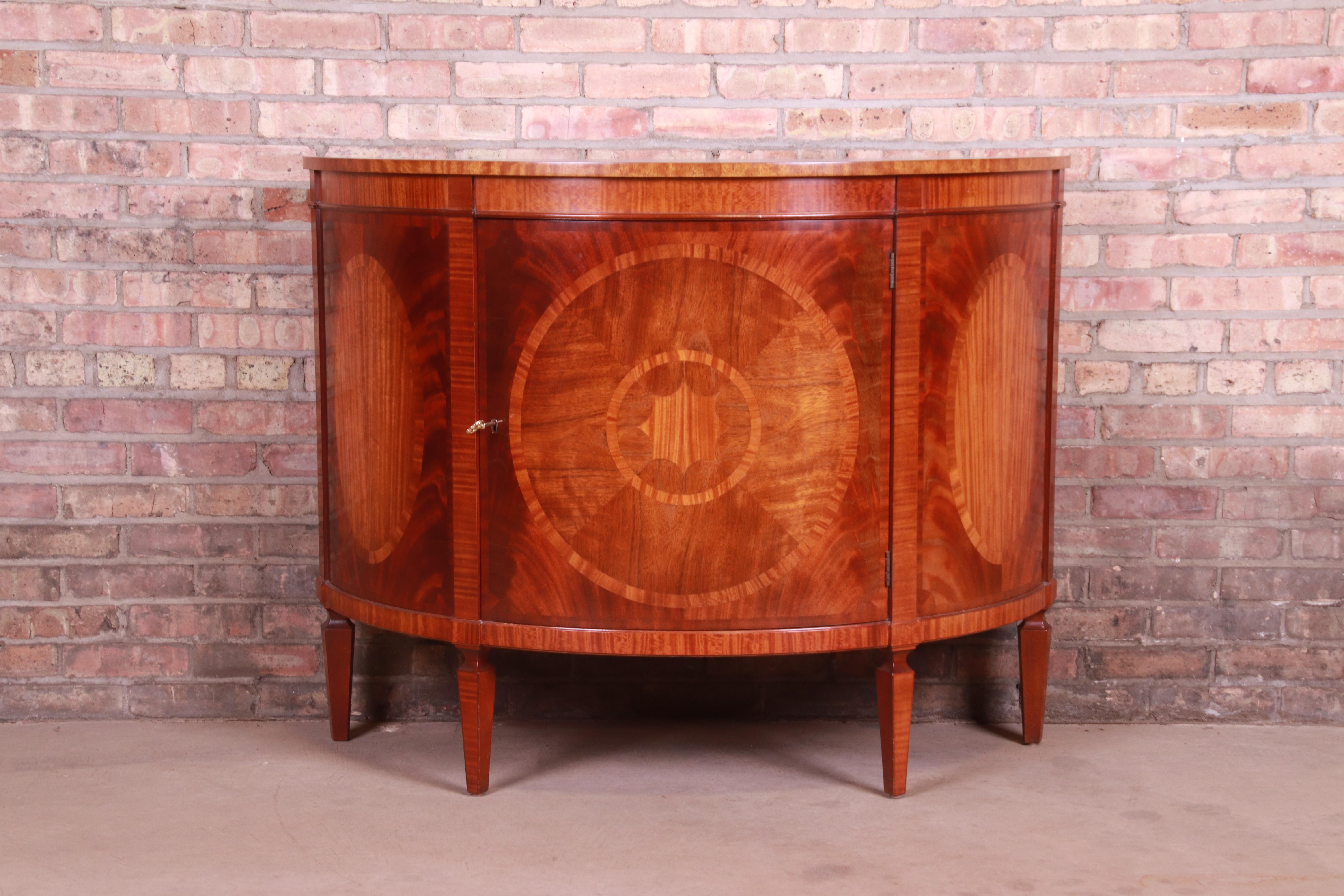 An exceptional Federal style demilune sideboard or bar cabinet

By Baker Furniture 