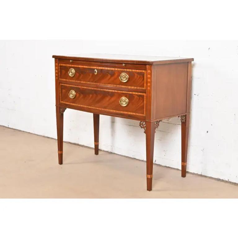 A gorgeous Federal or Hepplewhite style sideboard, buffet server, or console

By Baker Furniture

USA, Late 20th Century

Flame mahogany, with inlaid satinwood banding and marquetry, and original brass hardware.

Measures: 36
