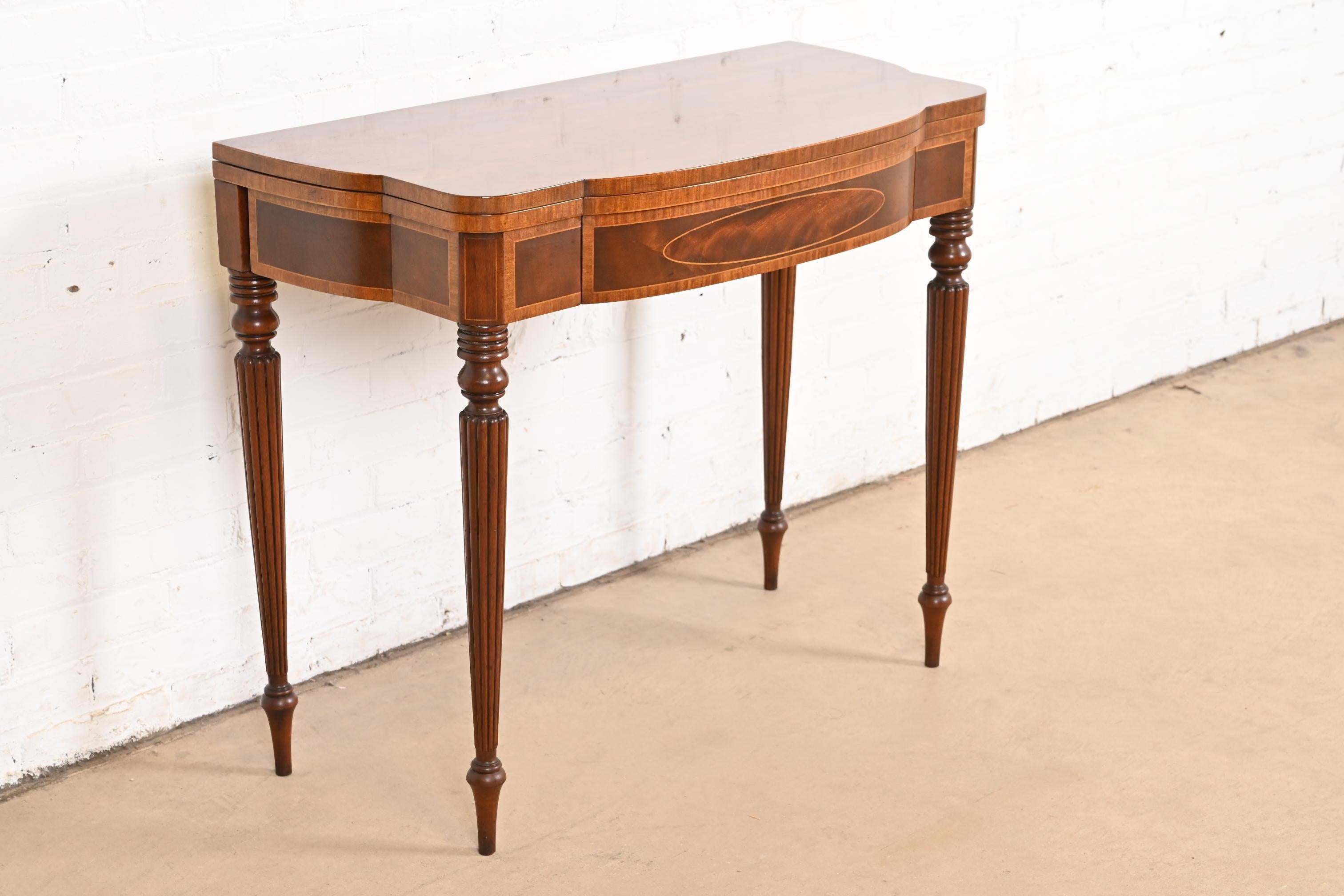 A gorgeous Federal or Hepplewhite style flip-top console or game table

By Baker Furniture

USA, Circa 1980s

Mahogany, with beautiful satinwood banding and inlaid marquetry.

Measures: 36