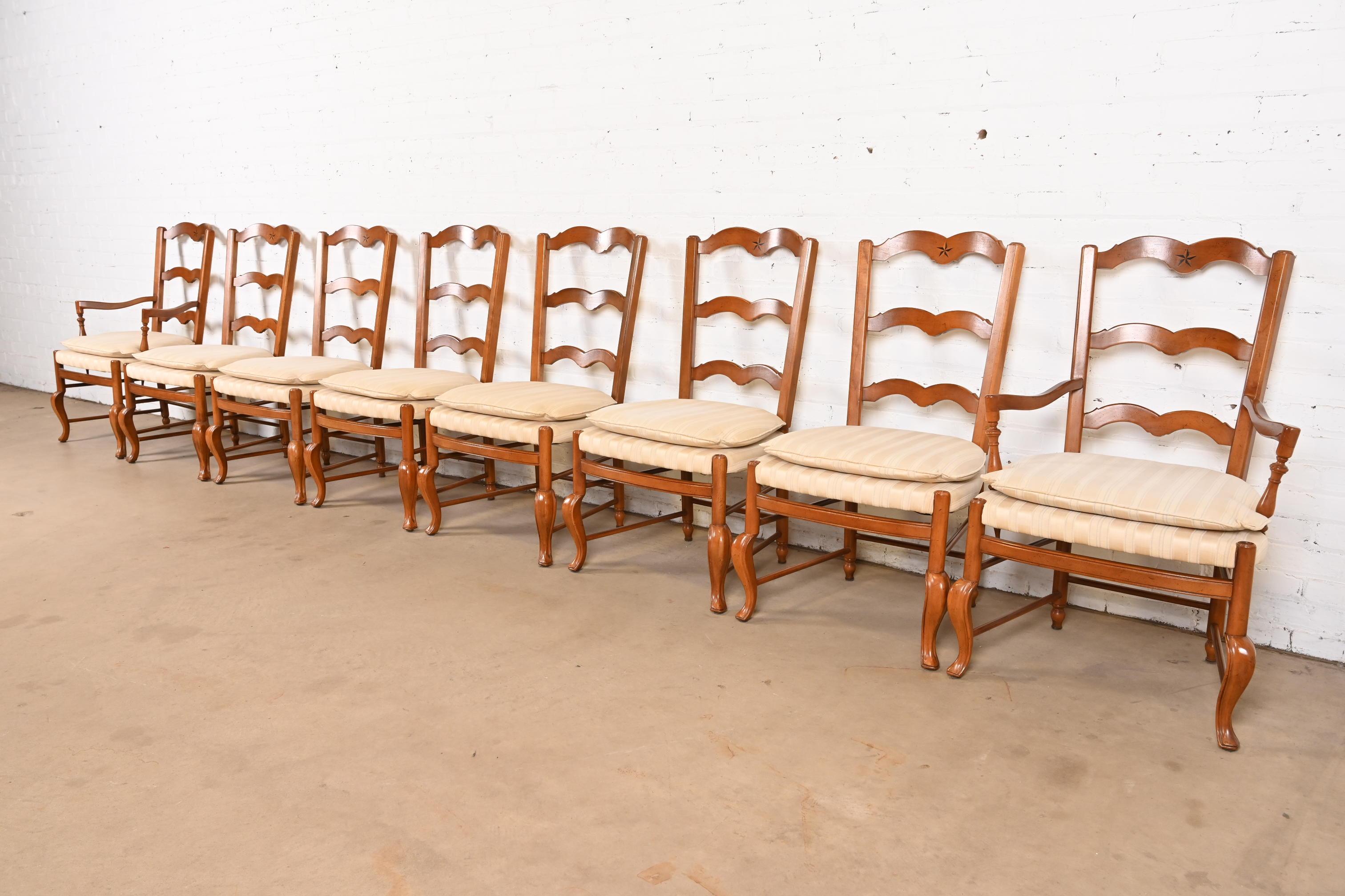 A gorgeous set of eight French Country or French Provincial Louis XV style dining chairs

By Baker Furniture

USA, Circa 1960s

Carved solid walnut frames, with inlaid marquetry, and upholstered seats.

Measures: 
Side Chairs - 22.75