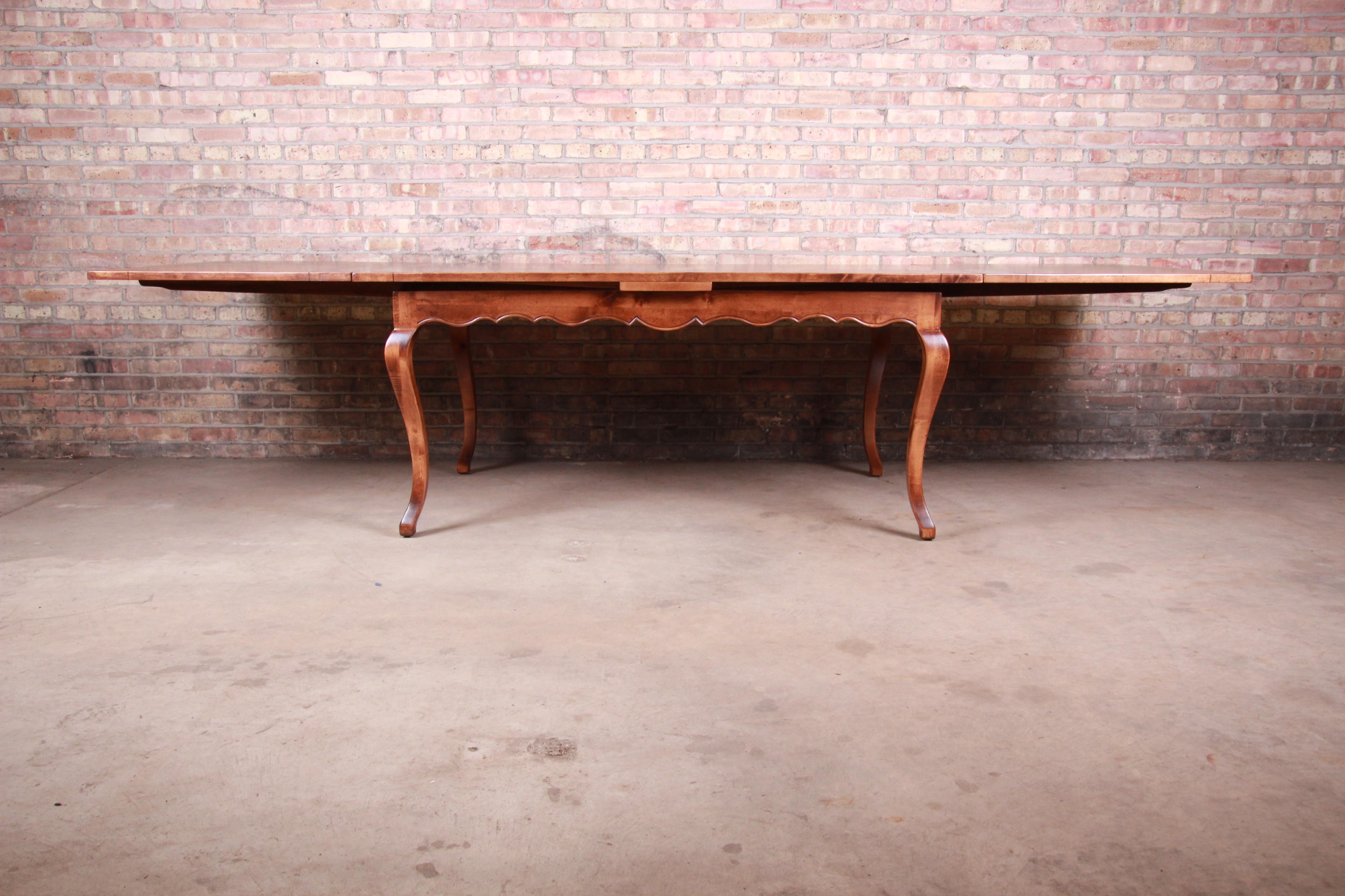 An exceptional solid maple French Country extension harvest dining table

By Baker Furniture 