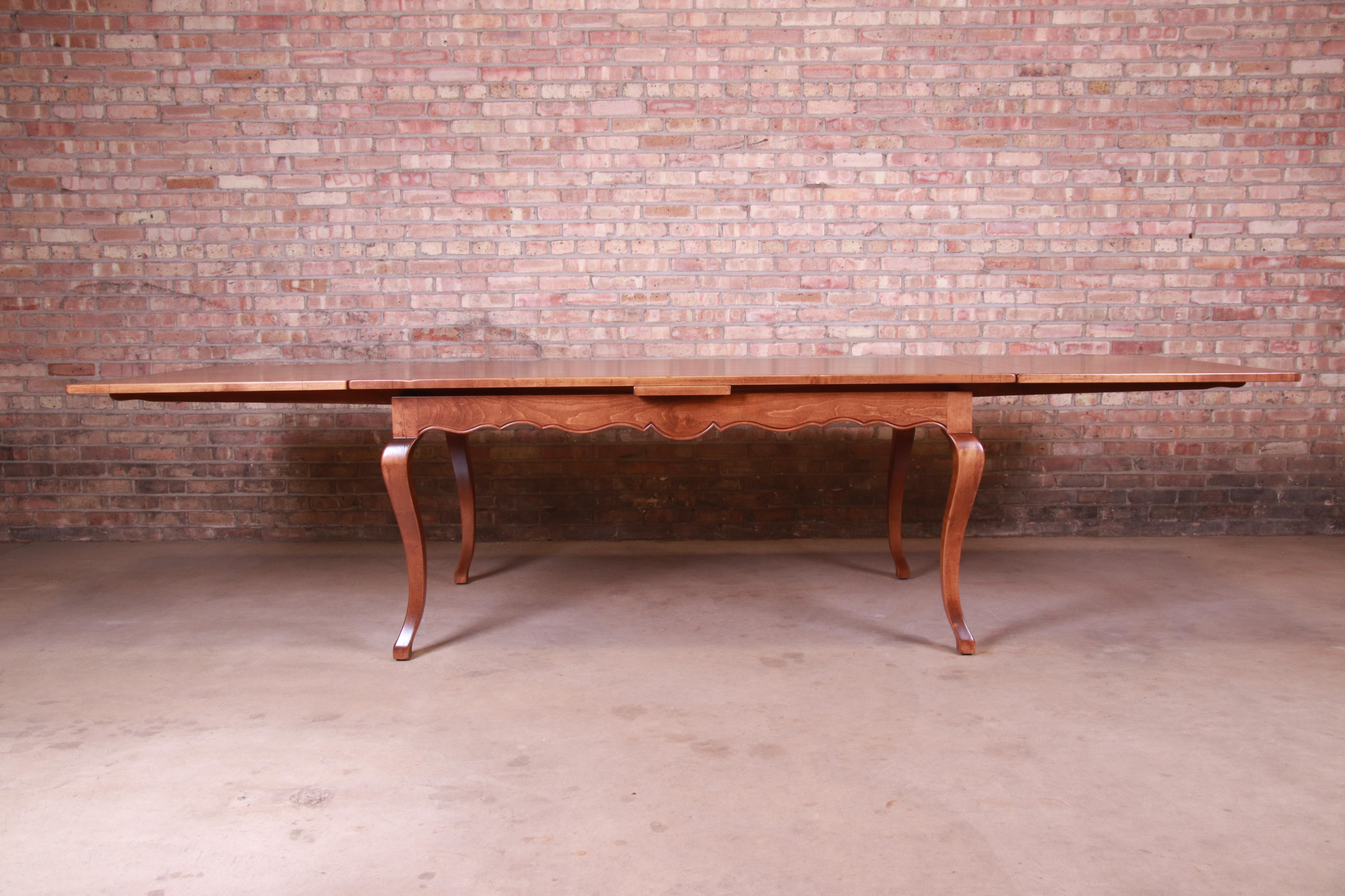 An exceptional solid maple French country extension harvest dining table

By Baker Furniture 