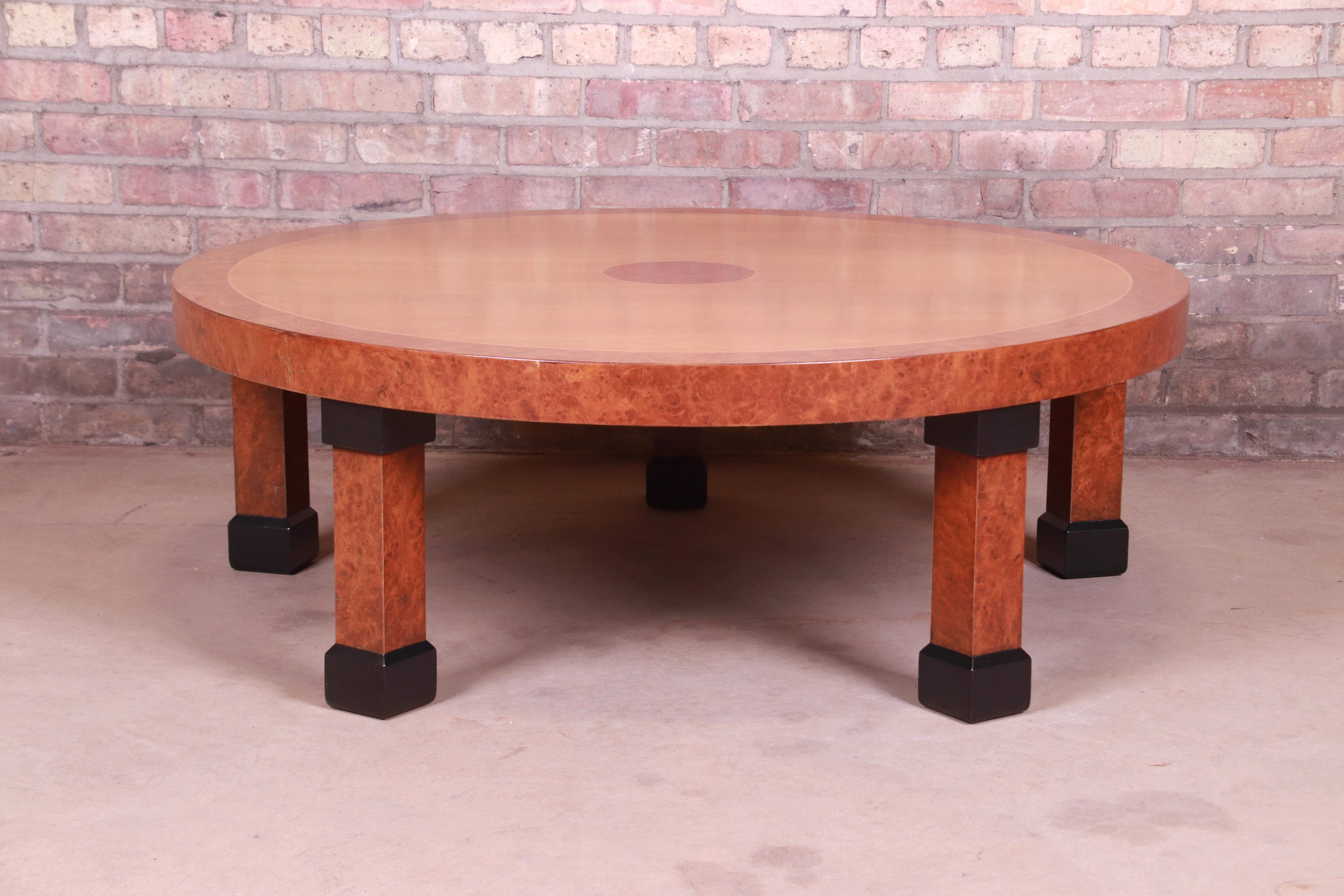 A gorgeous French Empire style coffee or cocktail table

By Baker Furniture

USA, Late 20th century

Cherry wood top, with burled walnut banding and legs and ebonized feet and accents.

Measures: 45