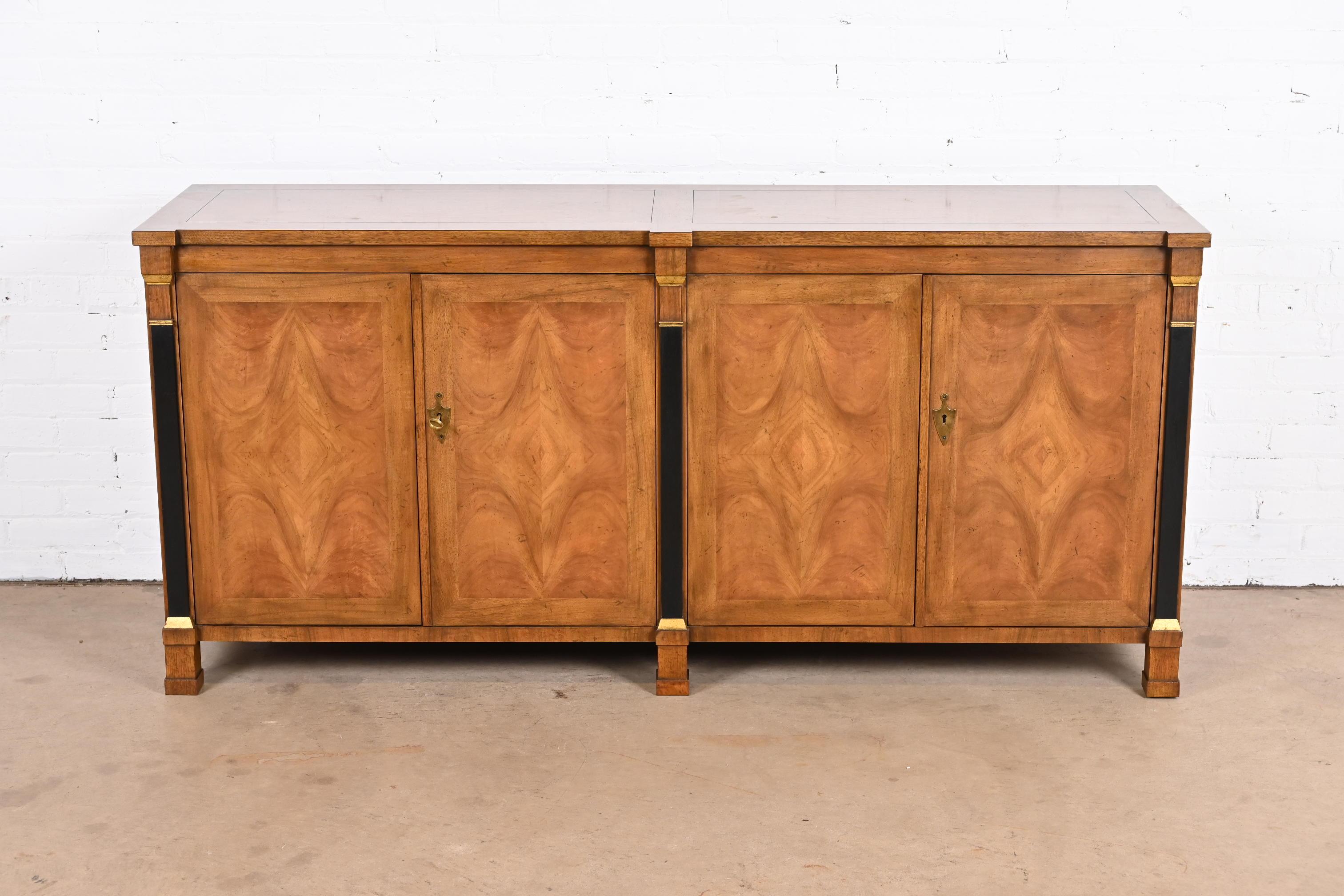 A gorgeous French Empire or neoclassical style sideboard, credenza, or bar cabinet

By Baker Furniture

USA, Circa 1960s

Stunning book-matched burled walnut, with ebonized and gold gilt columns, and original brass hardware. Cabinet locks, and