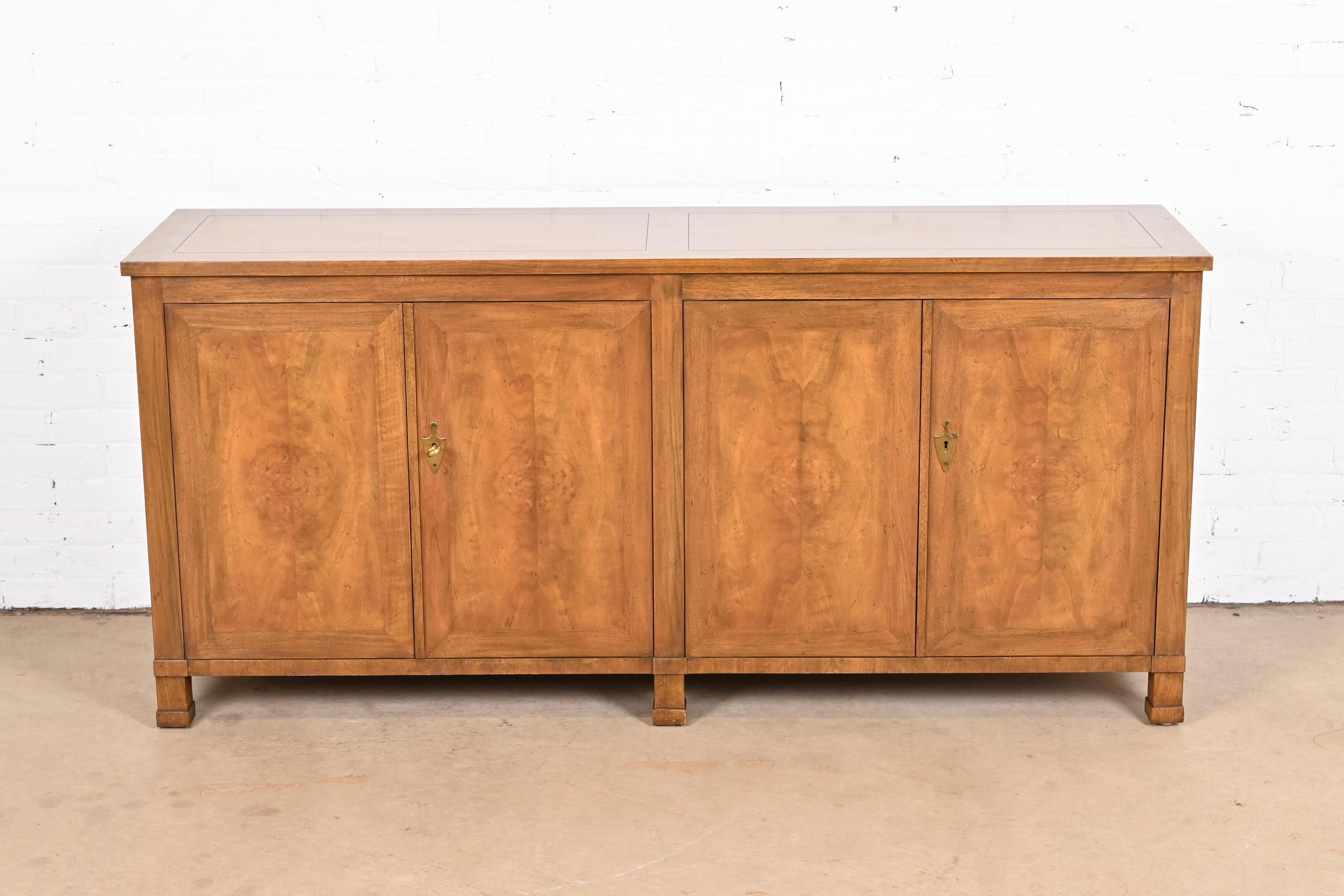 A gorgeous French Empire or Neoclassical style sideboard, credenza, or bar cabinet

By Baker Furniture

USA, Circa 1960s

Beautiful book-matched burled walnut, with original brass hardware. Cabinets lock, and key is included.

Measures: 70