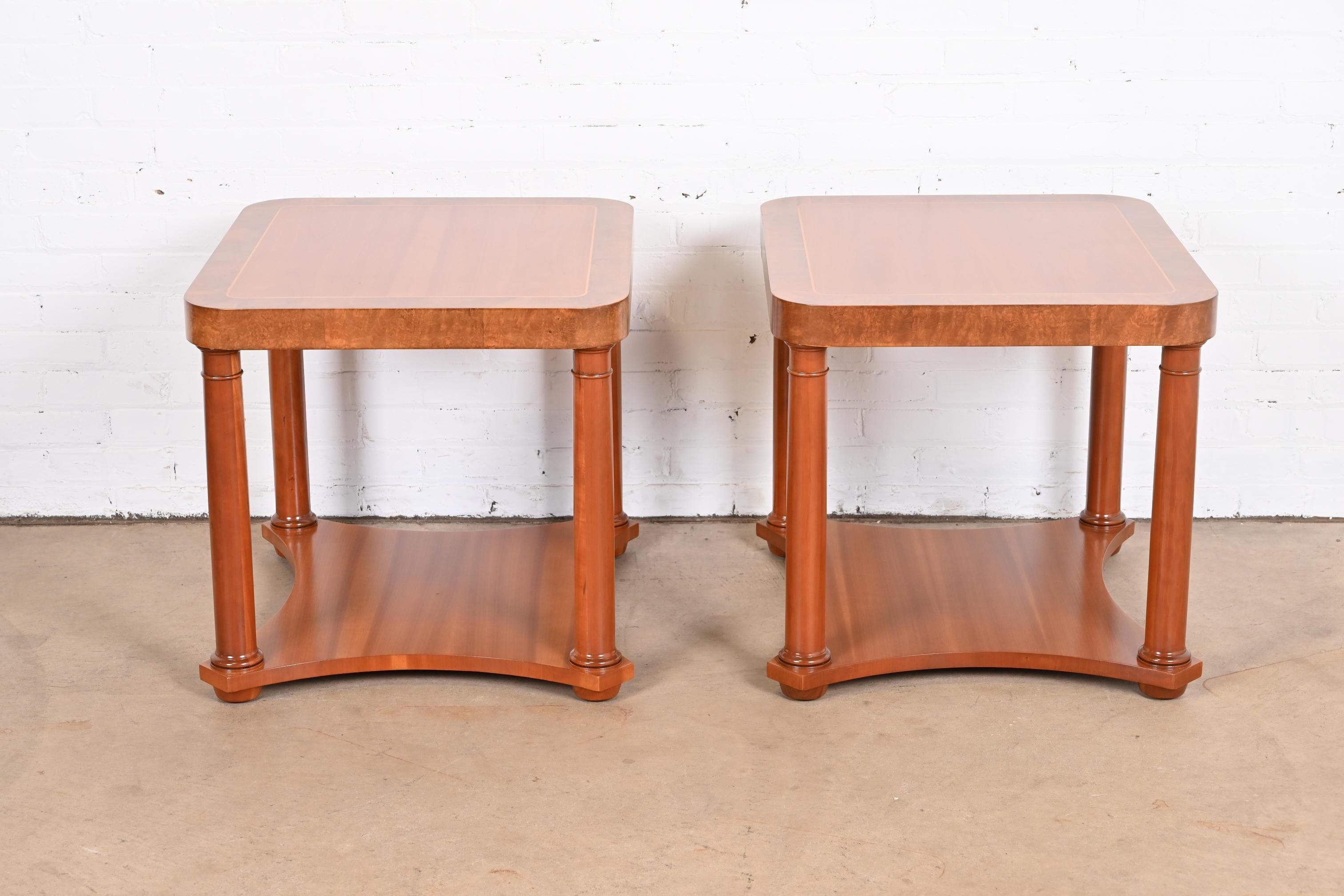 A gorgeous pair of French Empire style two-tier end tables or nightstands

By Baker Furniture

USA, Circa 1960s

Carved cherry wood, with burl wood banding and satinwood string inlay.

Measures: 24