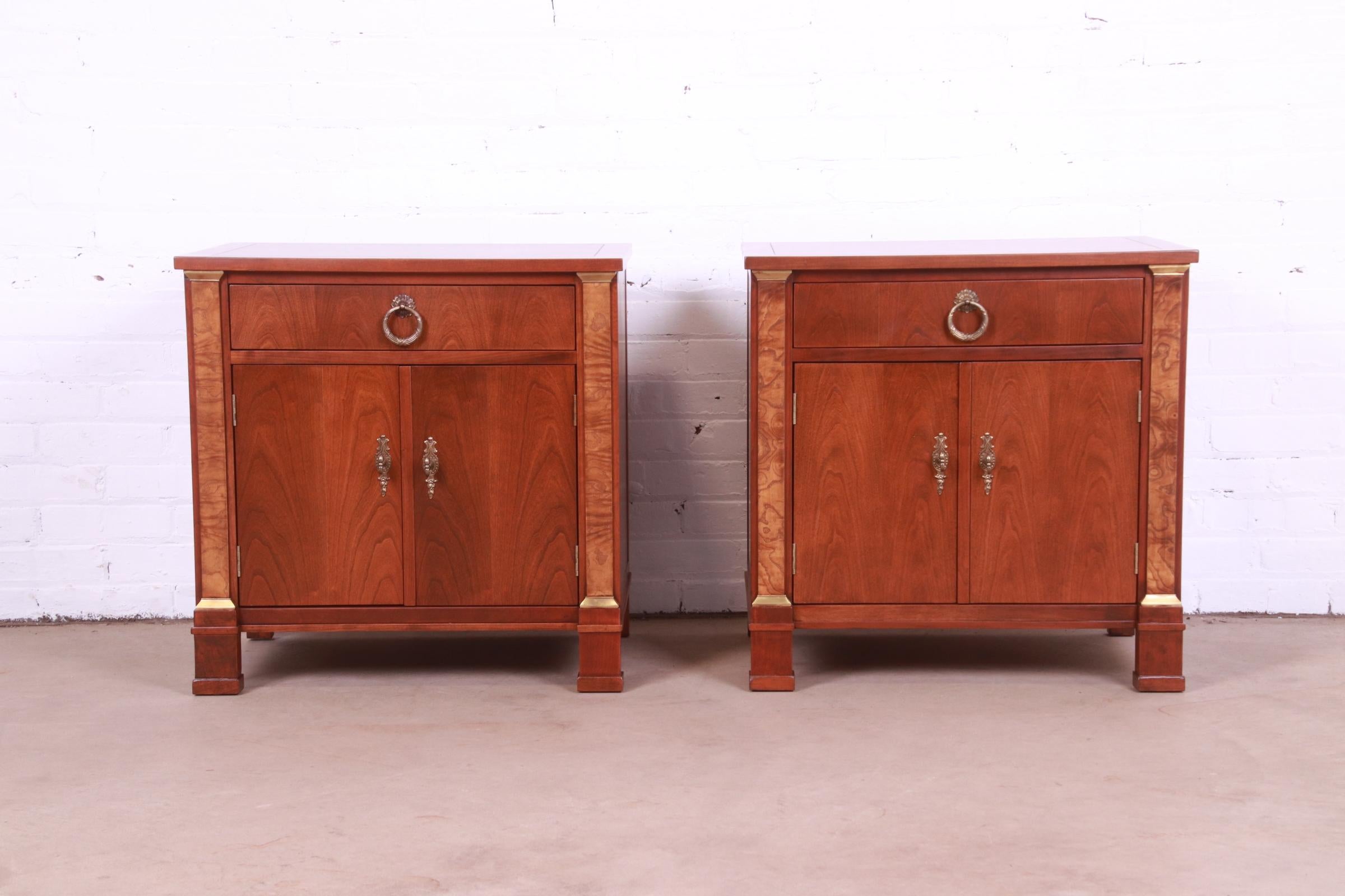 A gorgeous pair of French Empire style nightstands or end tables

By Baker Furniture

USA, Circa 1960s

Cherry wood, with burl wood columns and original brass hardware.

Measures: 25