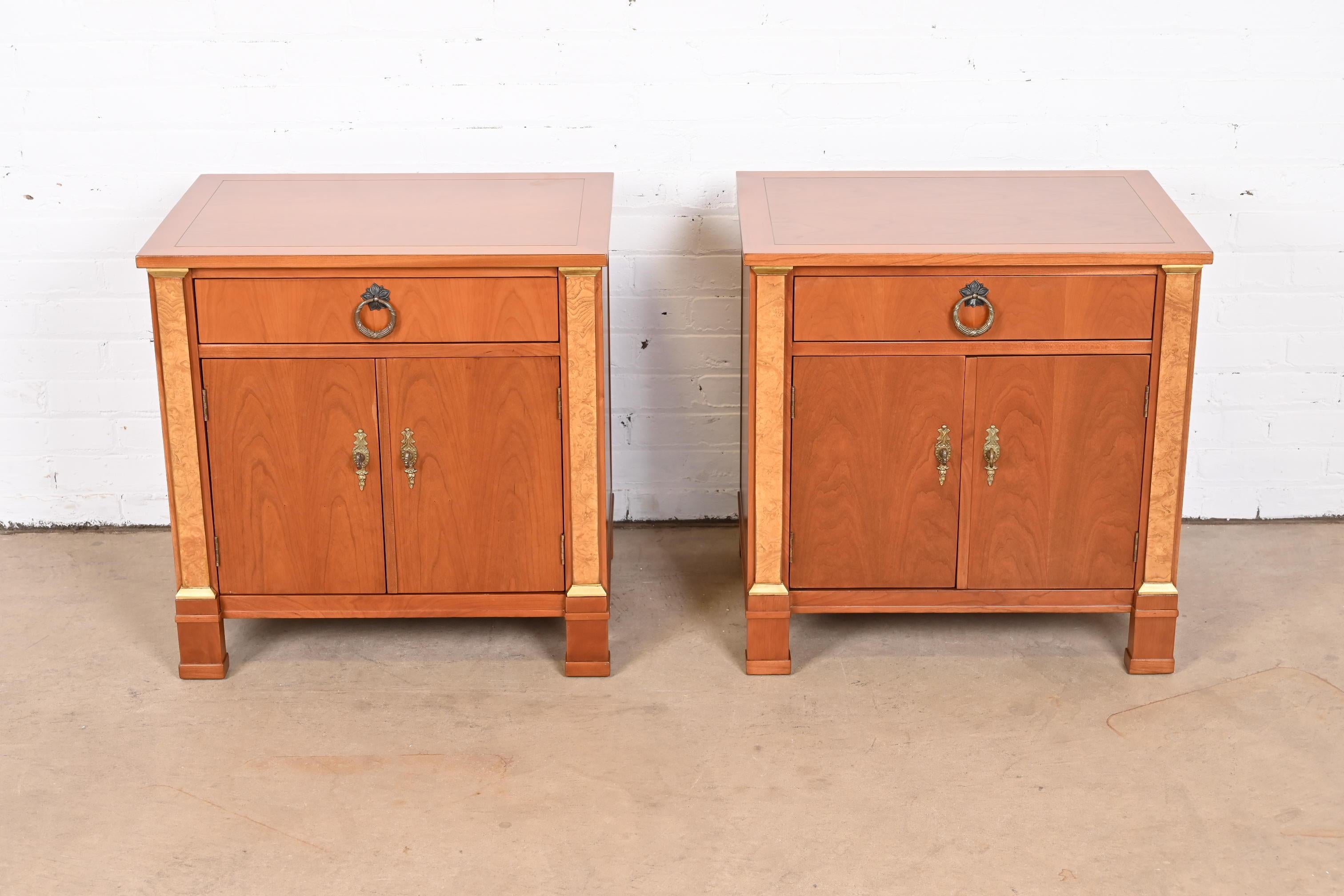 A gorgeous pair of French Empire style nightstands or end tables

By Baker Furniture

USA, Circa 1960s

Cherry wood, with burl wood columns and original brass hardware.

Measures: 25