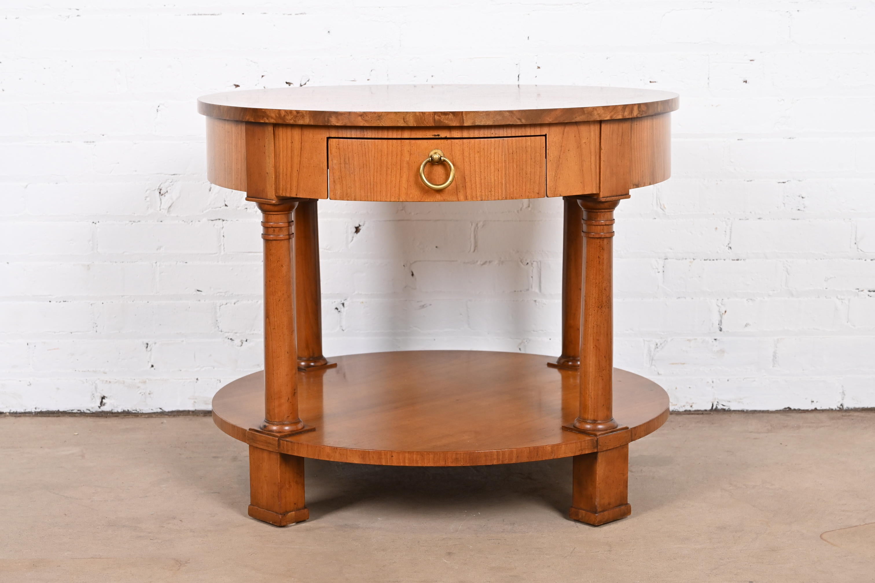 A gorgeous French Empire or Neoclassical style tea table or occasional side table

By Baker Furniture

USA, Circa 1980s

Cherry wood, with burled walnut banding on top and stunning inlaid starburst design.

Measures: 27