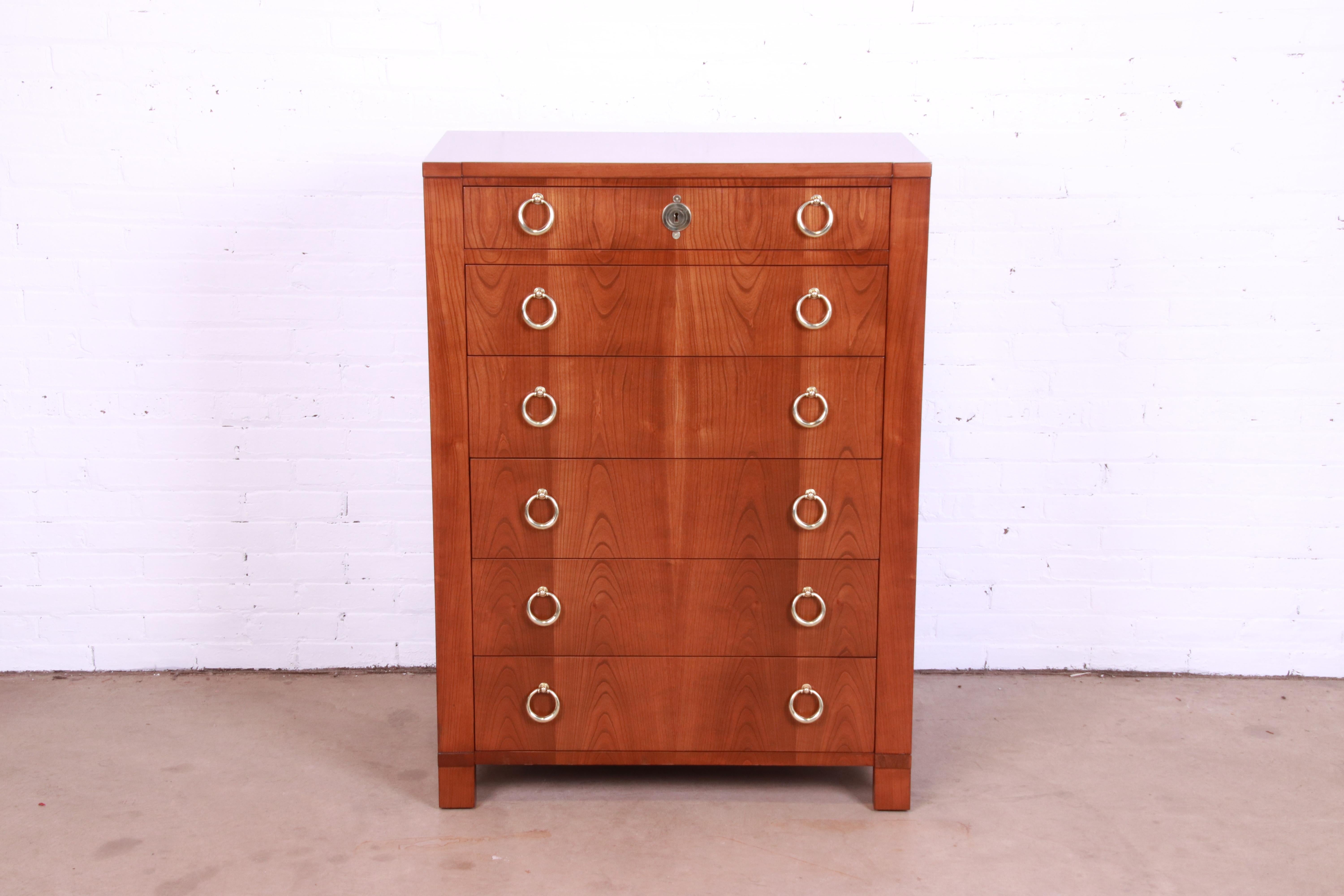 An outstanding French Empire style six-drawer highboy dresser chest

By Baker Furniture

USA, circa 1960s

Gorgeous book-matched cherry wood, with original brass hardware.

Measures: 34