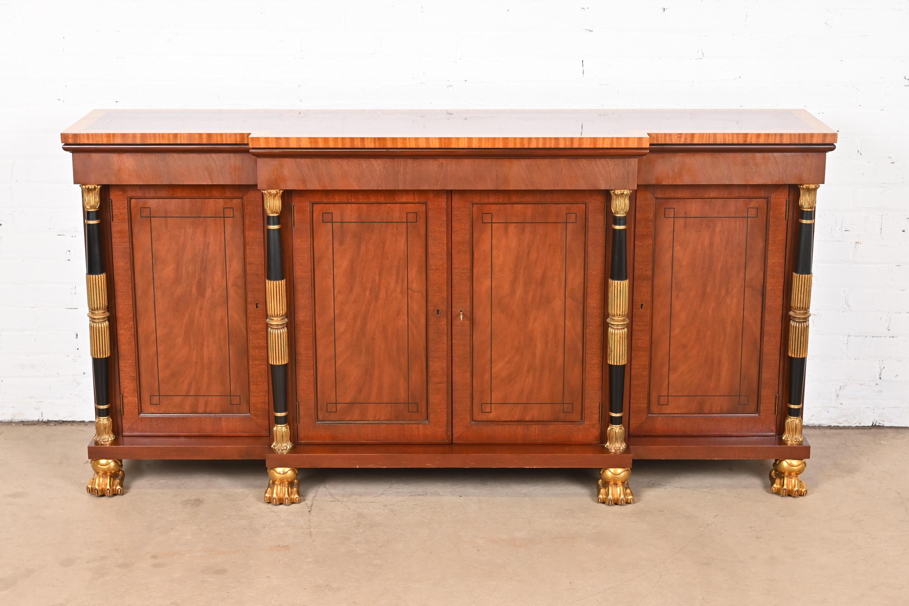 A gorgeous French Empire or French Regency Louis XVI style sideboard, credenza, or bar cabinet

By Baker Furniture

USA, Circa Late 20th Century

Stunning flame mahogany, with satinwood banding, ebony inlay, ebonized and gold gilt columns, gold gilt