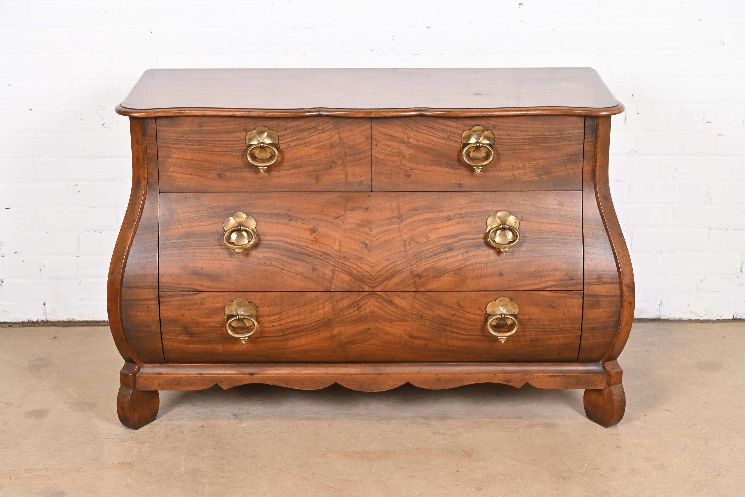 A gorgeous French Louis XV style bombay chest, commode, or dresser

By Baker Furniture

USA, Circa 1960s

Burled walnut, with original brass hardware.

Measures: 46