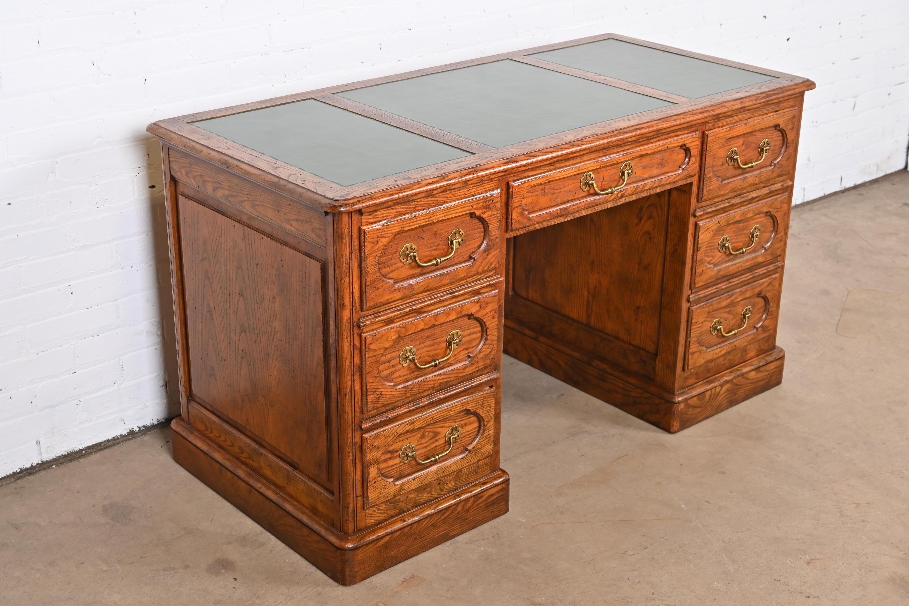 Brass Baker Furniture French Provincial Carved Oak Leather Top Desk, circa 1960s