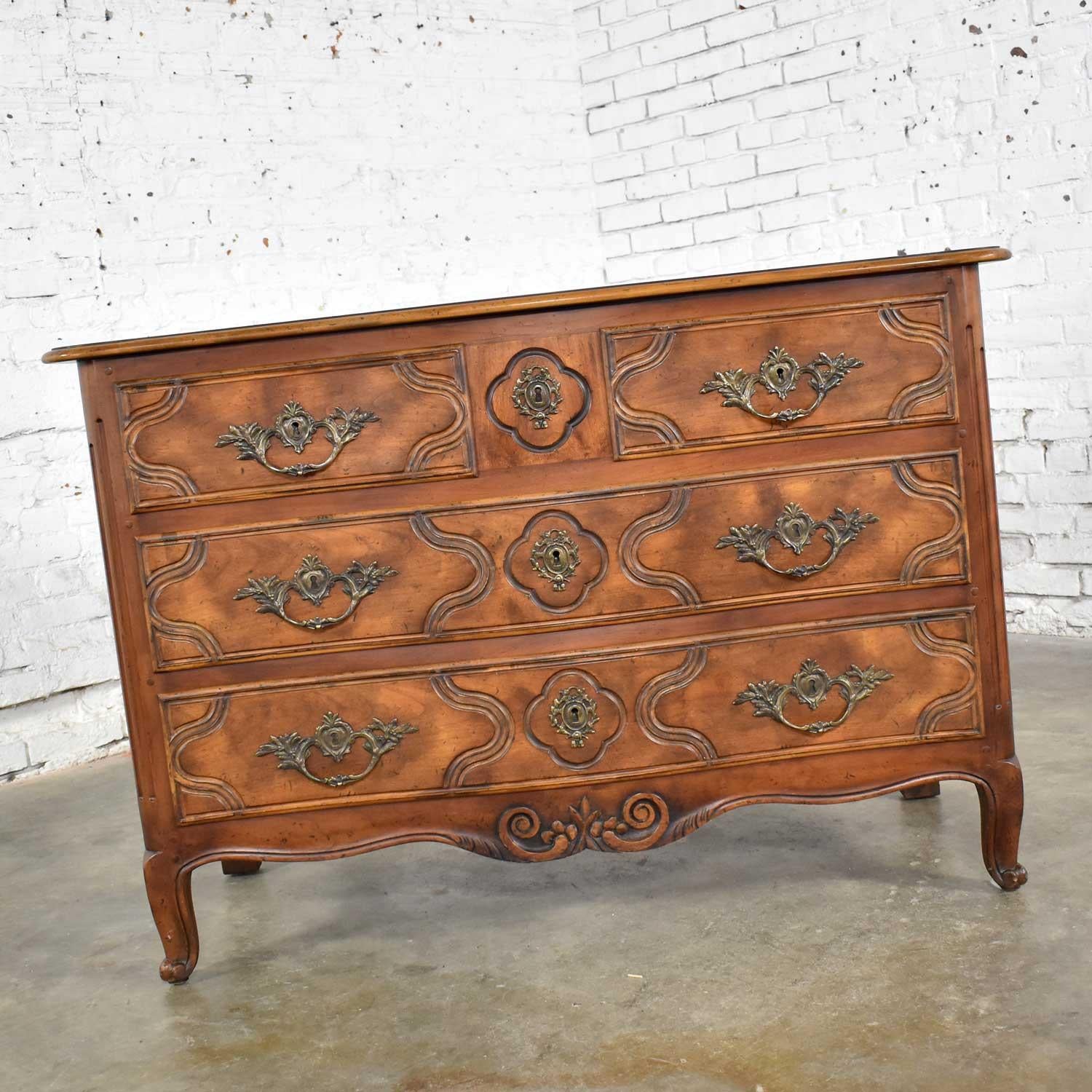 Handsome Baker Furniture bachelor’s chest of drawers in the Country French Provincial style. It is in fabulous vintage condition apart from a slight raising of wood grain on places of the top which can only be felt and not seen. Please see photos,