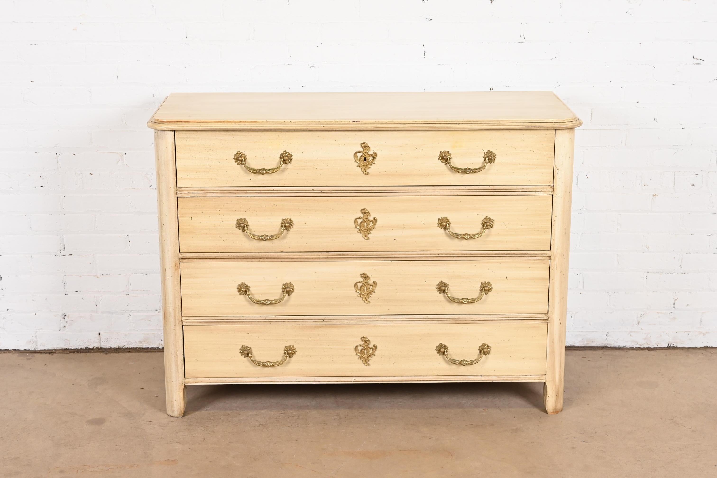 A gorgeous French Provincial Louis XV style dresser or chest of drawers

By Baker Furniture

USA, Circa 1960s

Cream painted walnut, with original brass hardware.

Measures: 48.25
