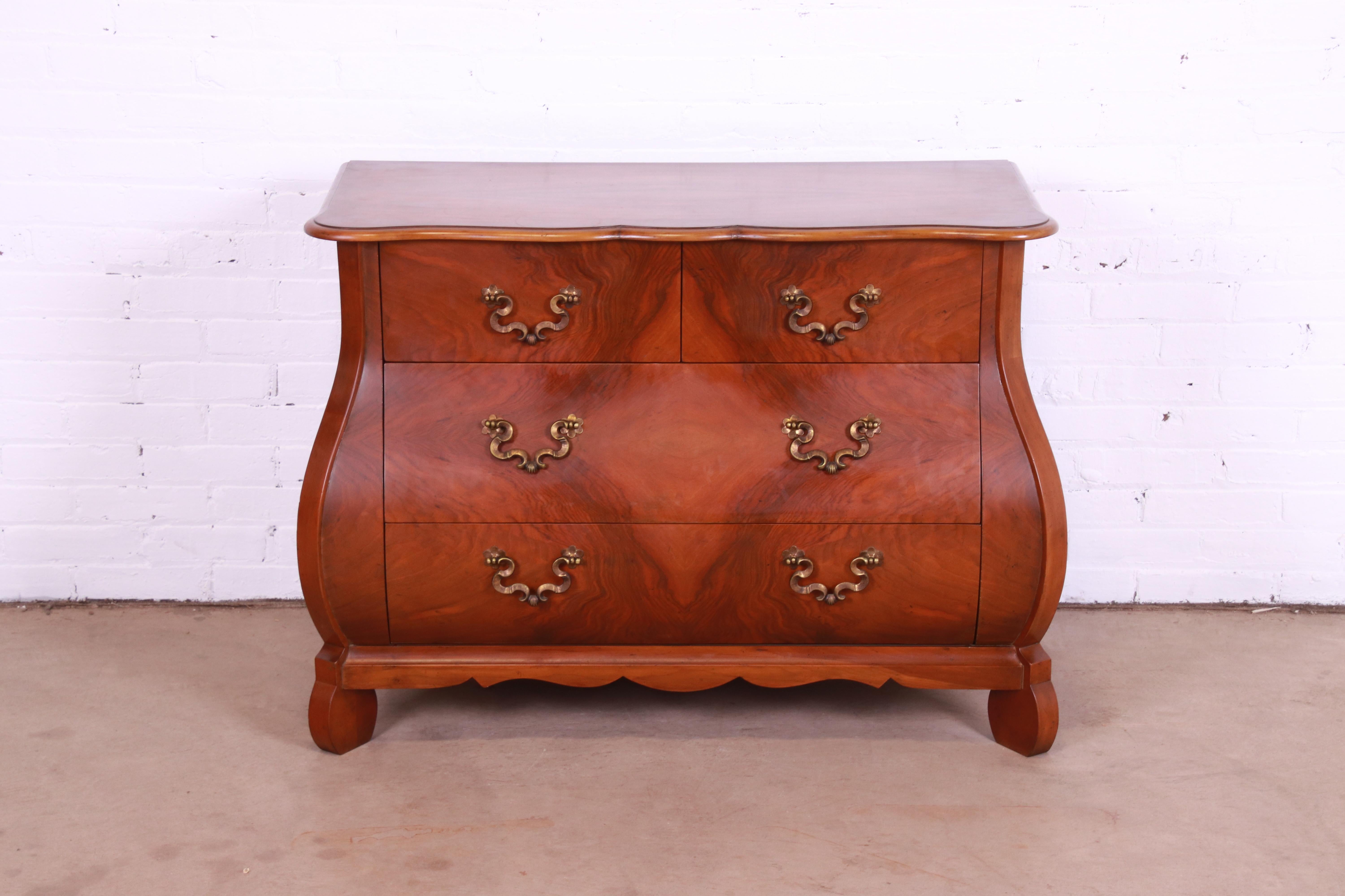 A gorgeous French Provincial Louis XV style bombay chest, commode, or dresser

By Baker Furniture

USA, Circa 1980s

Burled walnut, with original brass hardware.

Measures: 42.5