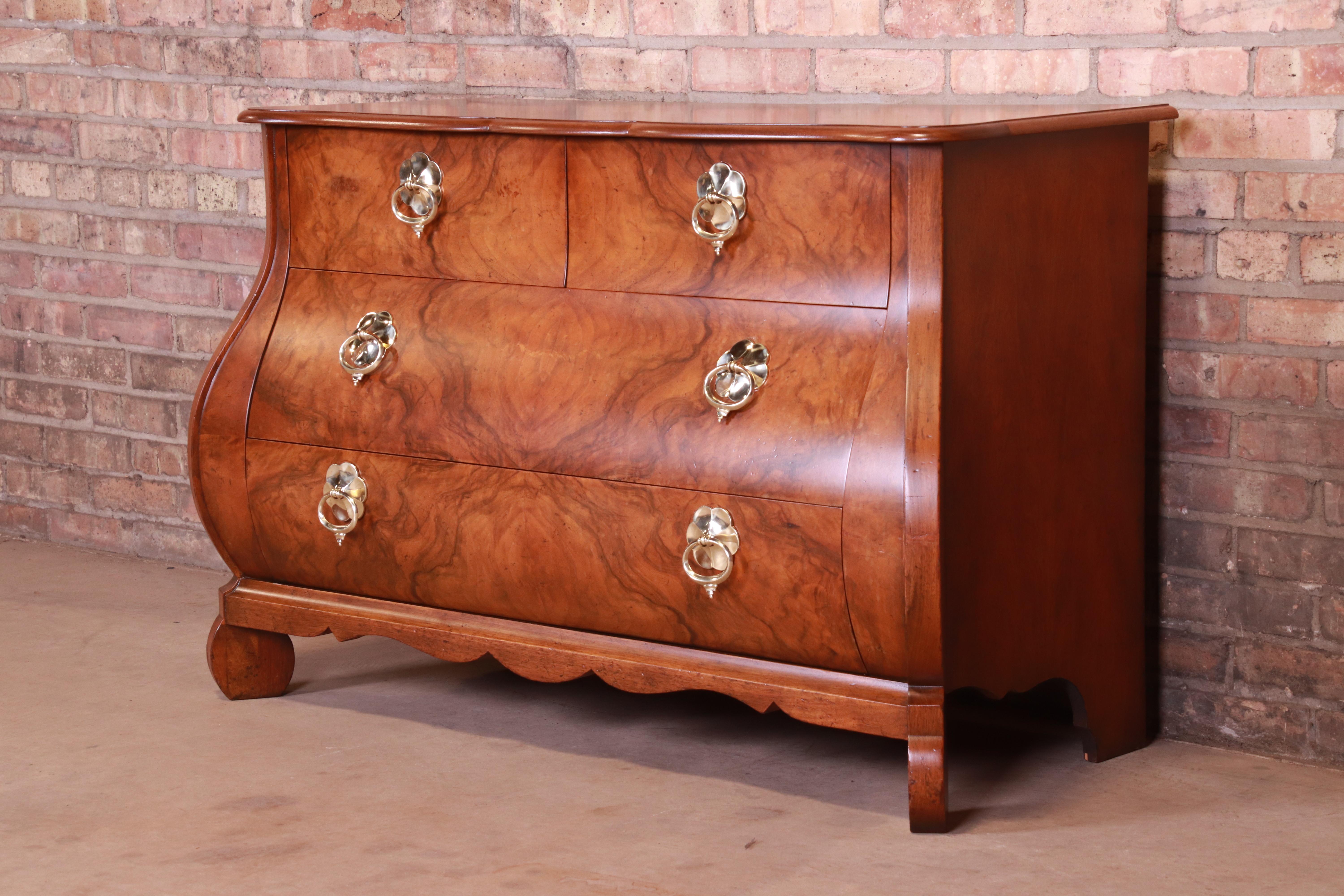 A gorgeous French Provincial Louis XV style Bombay chest or commode

By Baker Furniture,

USA, circa 1960s

Burled walnut, with original brass hardware.

Measures: 47