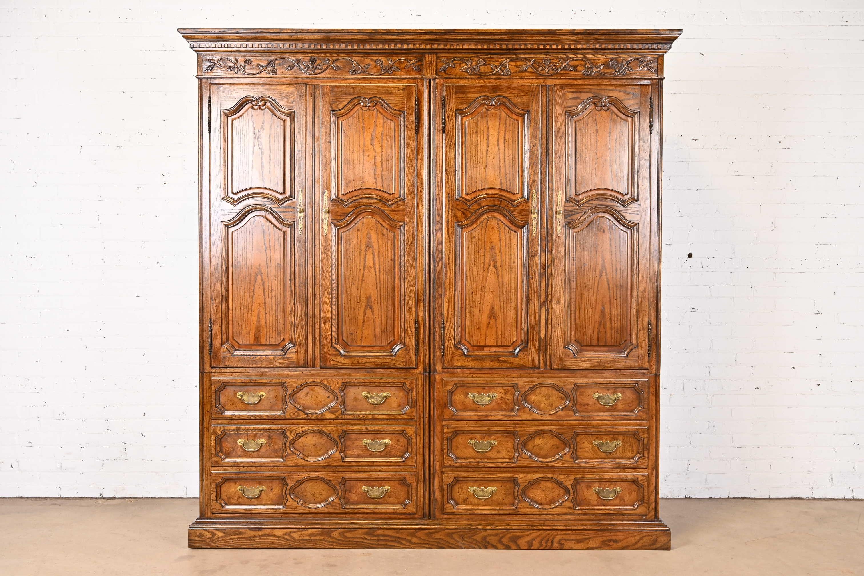 A gorgeous French Provincial Louis XV style double armoire dresser or linen press

By Baker Furniture

USA, Circa 1960s

Carved oak, with inset burl wood on drawer fronts, and original brass hardware.

Measures: 80.75
