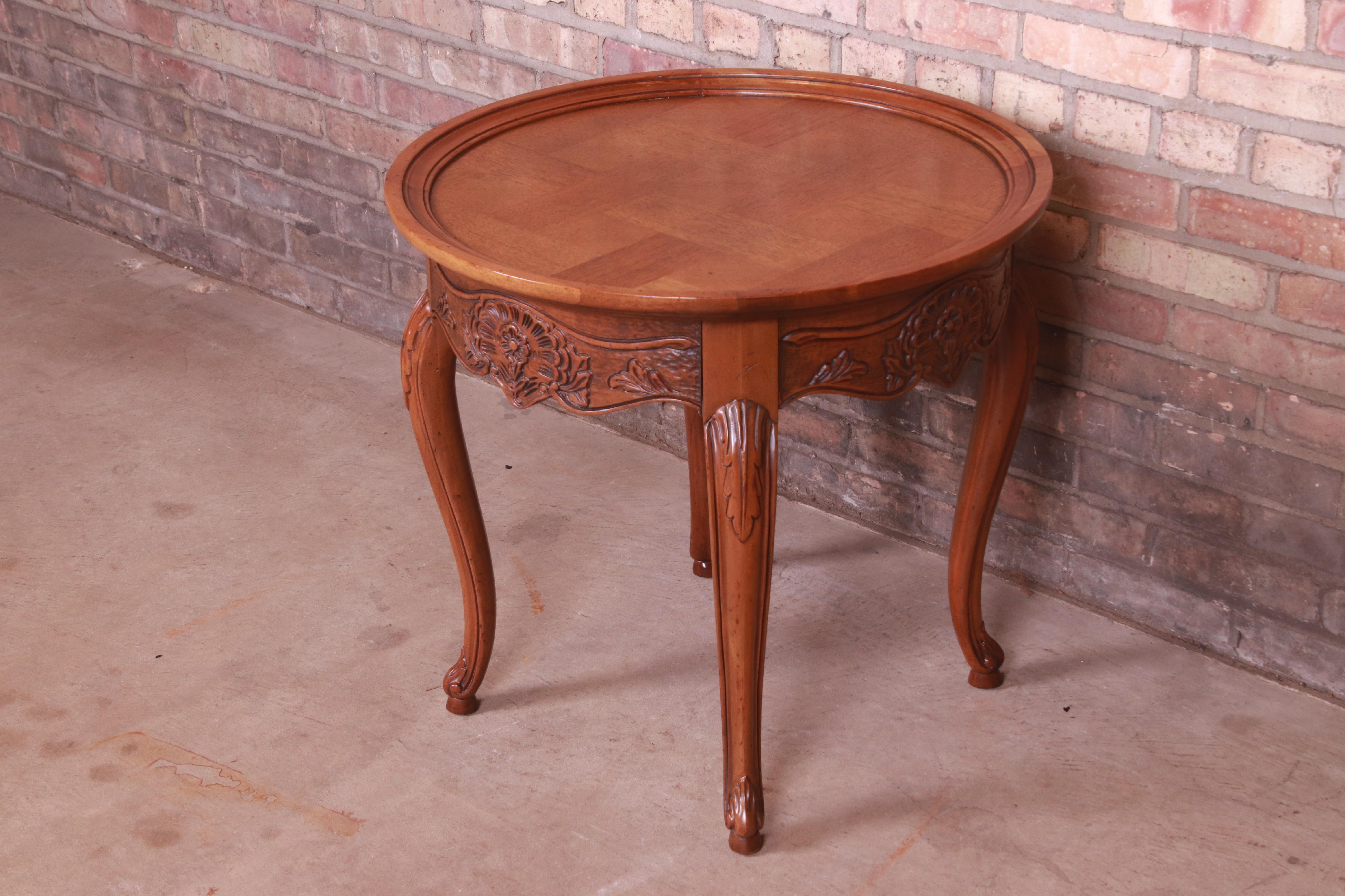 A gorgeous French Provincial Louis XV style occasional side table or tea table

By Baker Furniture

USA, Circa 1960s

Carved oak, with parquetry top.

Measures: 25.75
