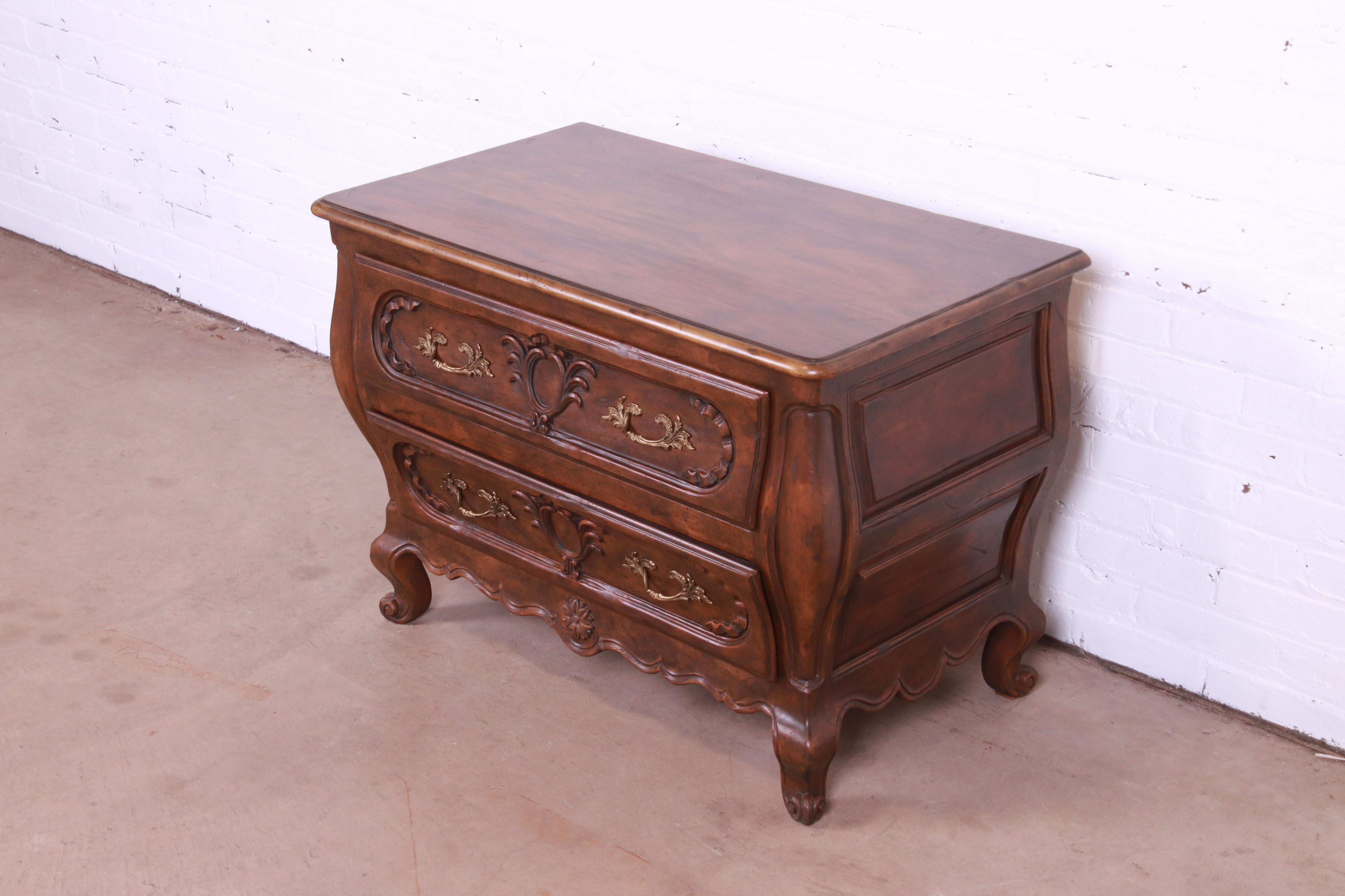 A gorgeous French Provincial Louis XV style bombay form dresser, commode, or chest of drawers

By Baker Furniture

USA, Circa 1960s

Carved walnut, with original brass hardware.

Measures: 36.25