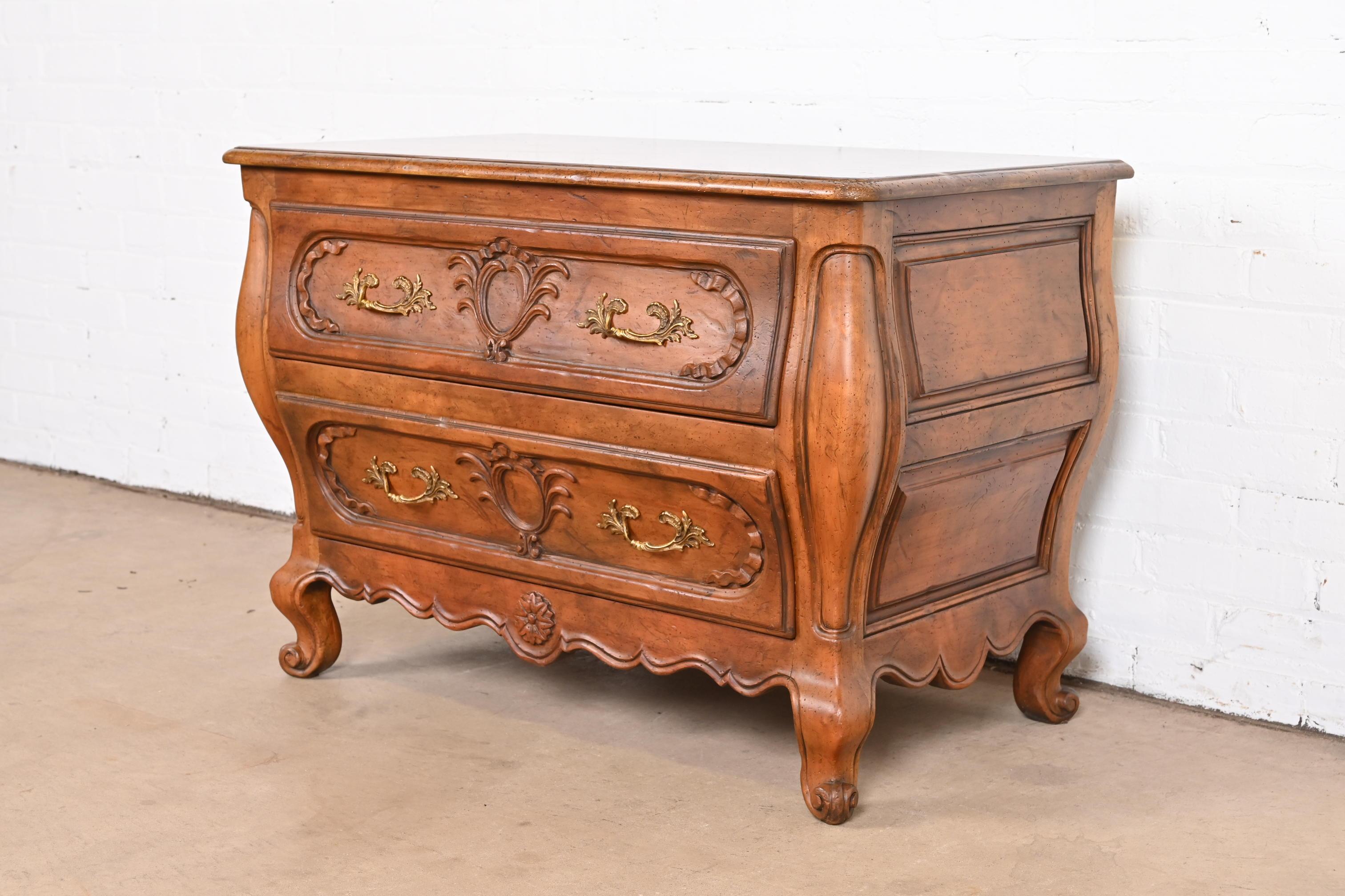 A gorgeous French Provincial Louis XV style bombay form dresser, commode, or chest of drawers

By Baker Furniture

USA, Circa 1960s

Carved walnut, with original brass hardware.

Measures: 36