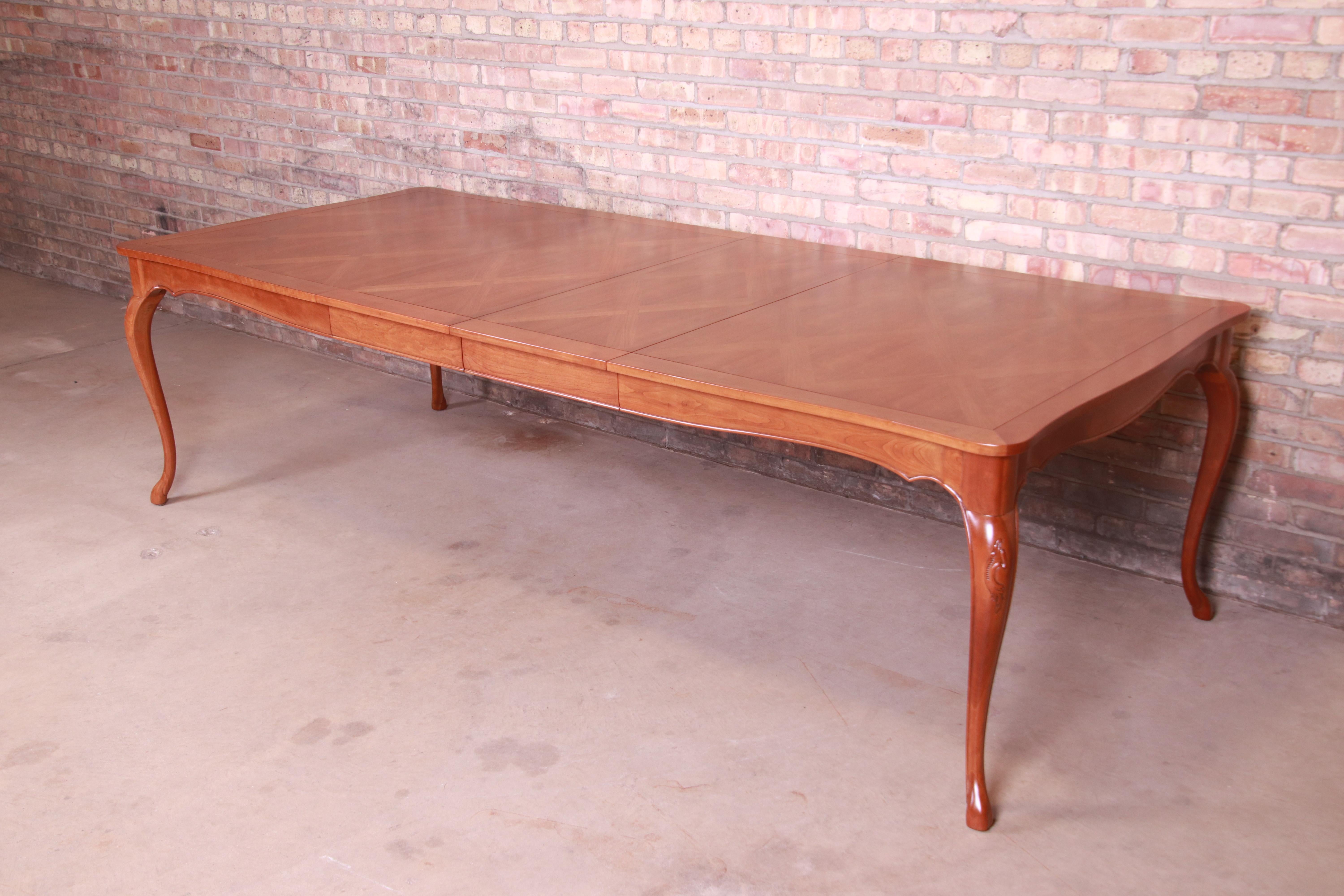 An exceptional French Provincial Louis XV style extension dining table

By Baker Furniture

USA, circa 1960s

Cherrywood, with parquet top.

Measures: 67.75