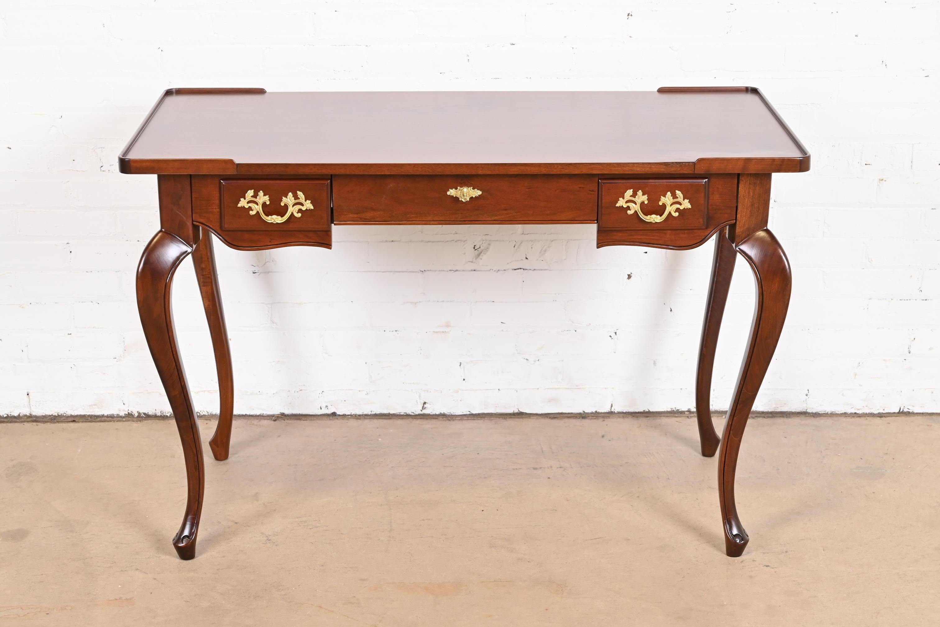 An exceptional French Provincial Louis XV style writing desk

By Baker Furniture

USA, Circa 1960s

Carved cherry wood, with original brass hardware.

Measures: 46