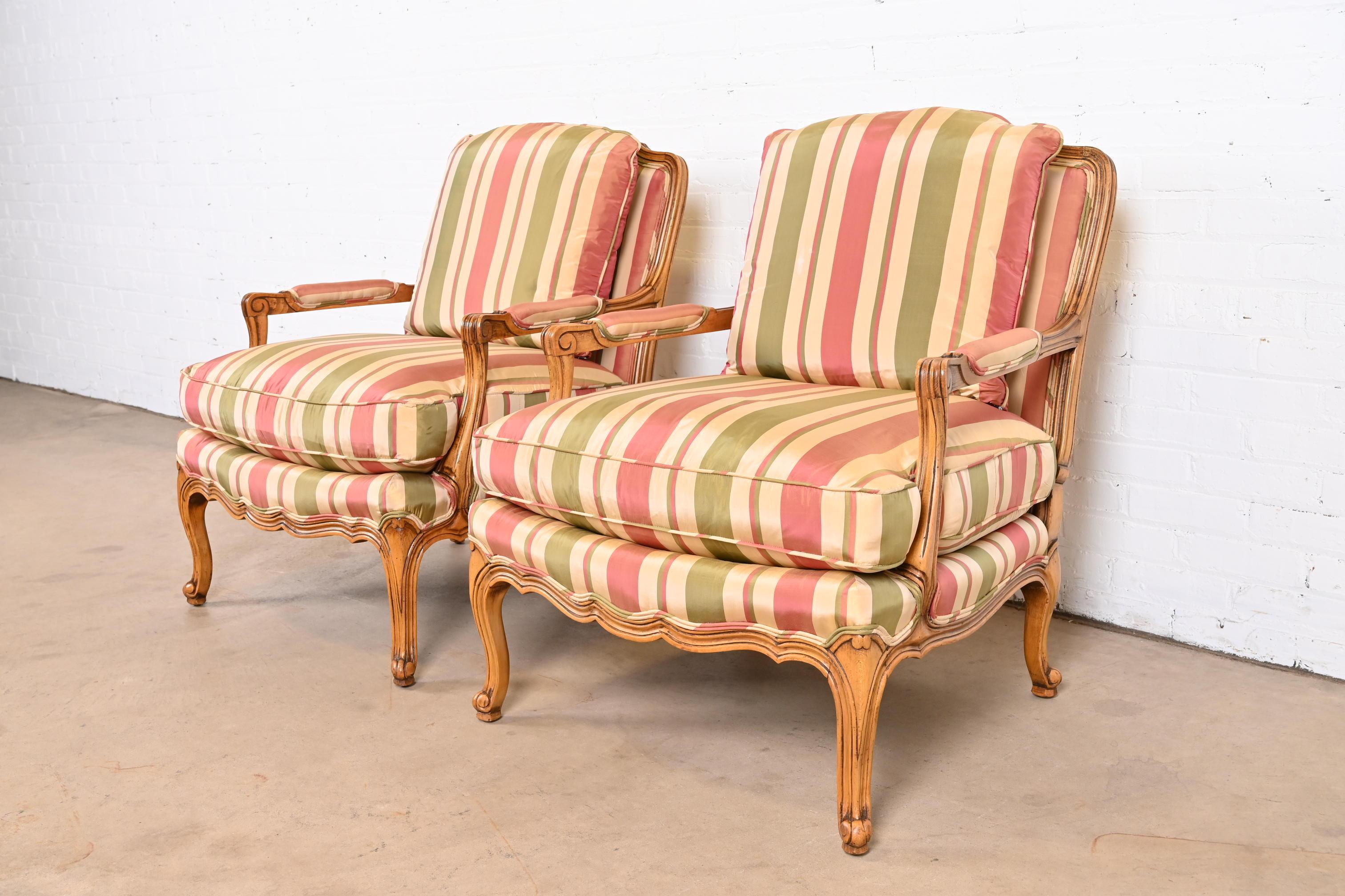 A gorgeous pair of French Provincial Louis XV style upholstered lounge chairs

By Baker Furniture

USA, Circa 1980s

Carved walnut frames, with upholstered seats and backs.

Measures: 28.5