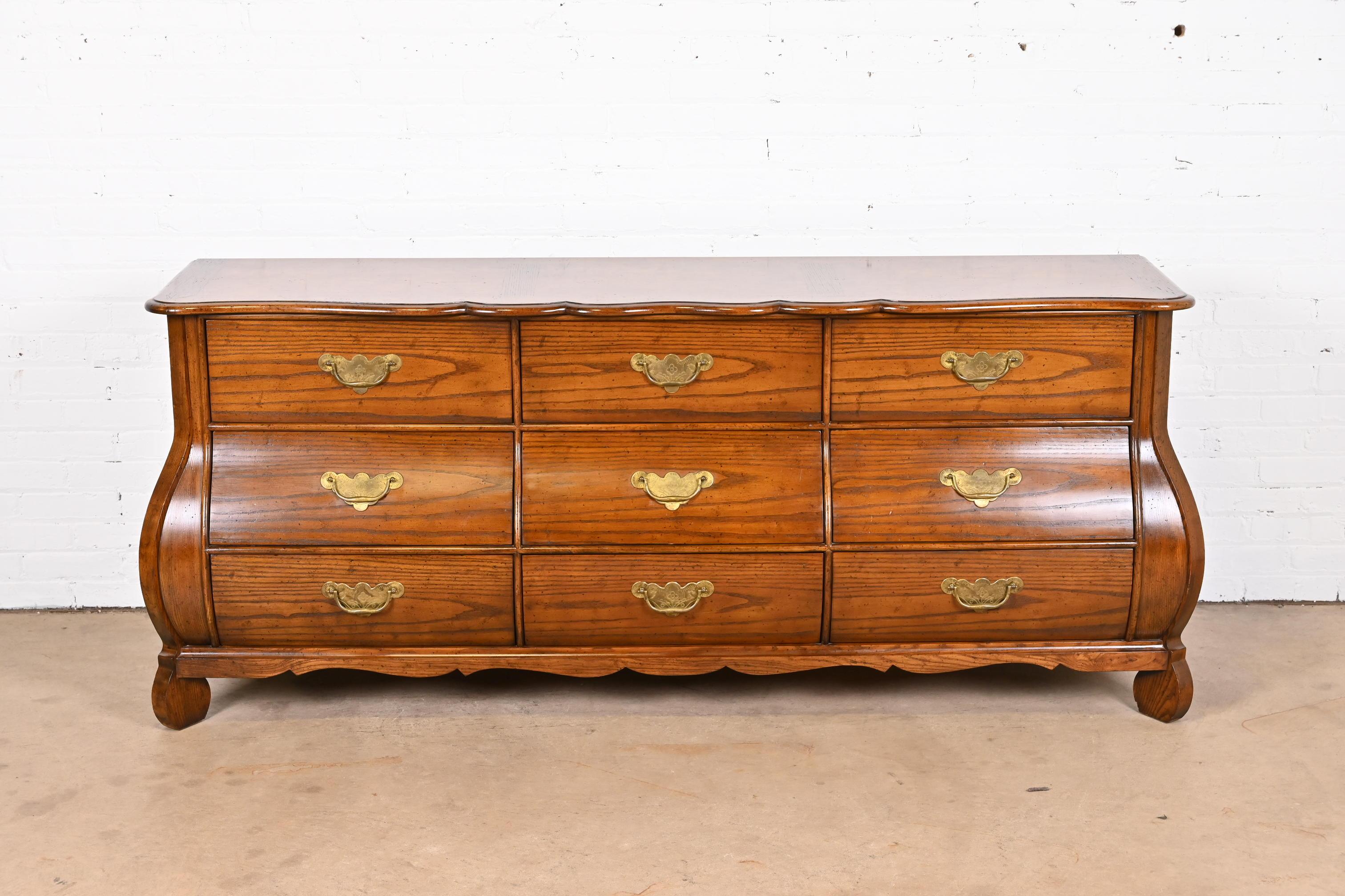 A gorgeous French Provincial Louis XV style bombay form triple dresser or credenza

By Baker Furniture, 