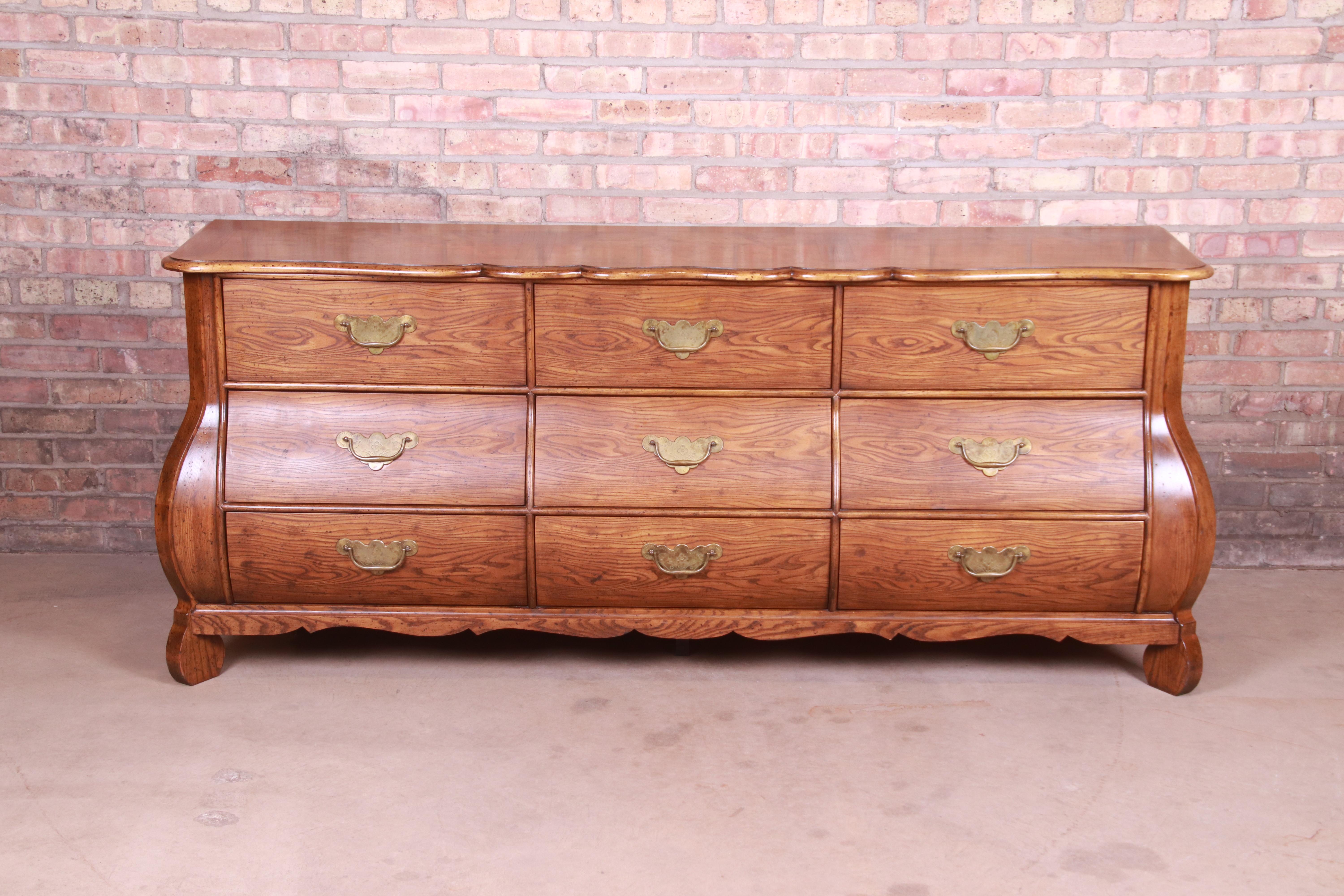 An exceptional French Provincial Louis XV style bombe form triple dresser or credenza

By Baker Furniture 